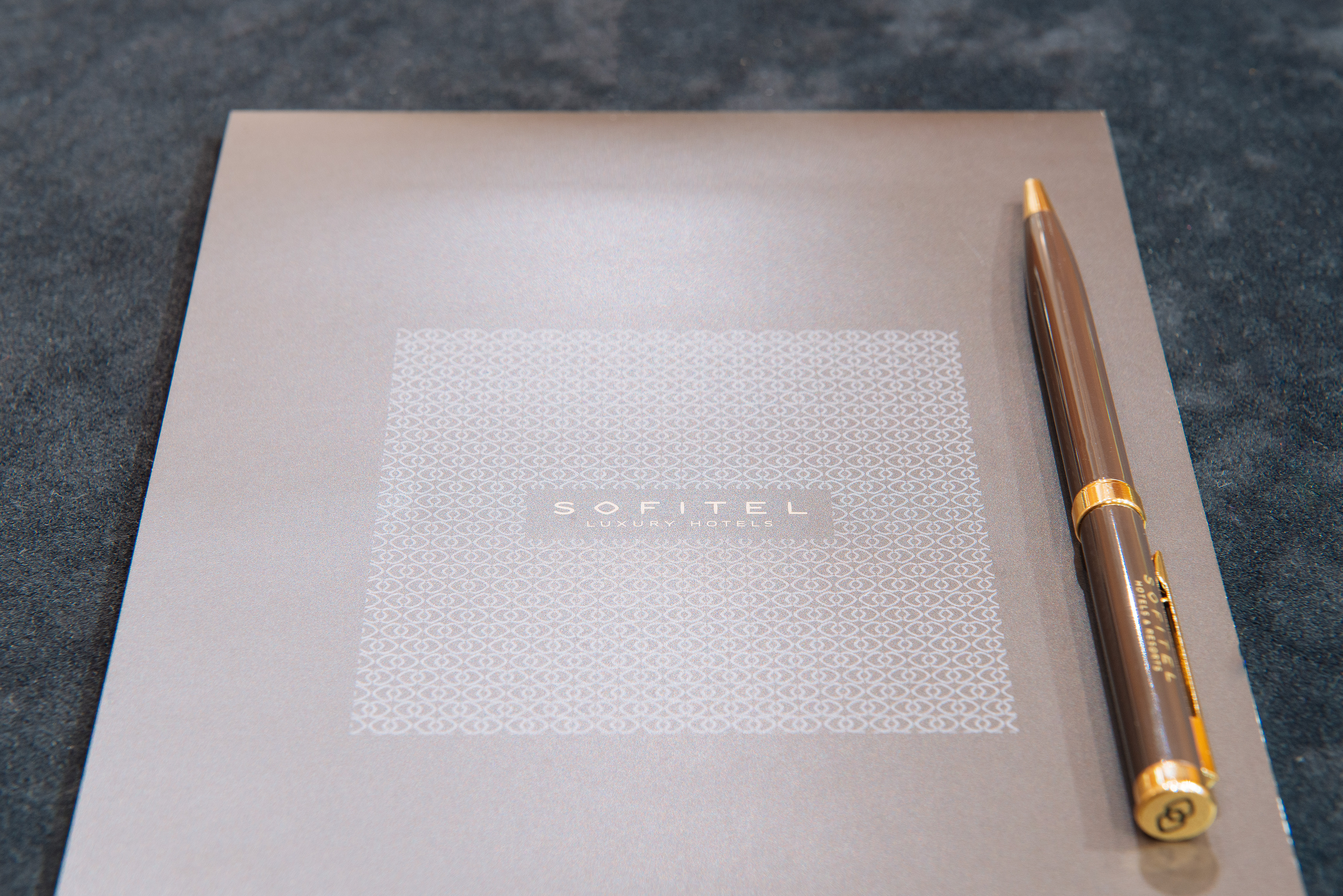 Polished meeting setup with branded notepad and pen at Sofitel London Gatwick for corporate events.