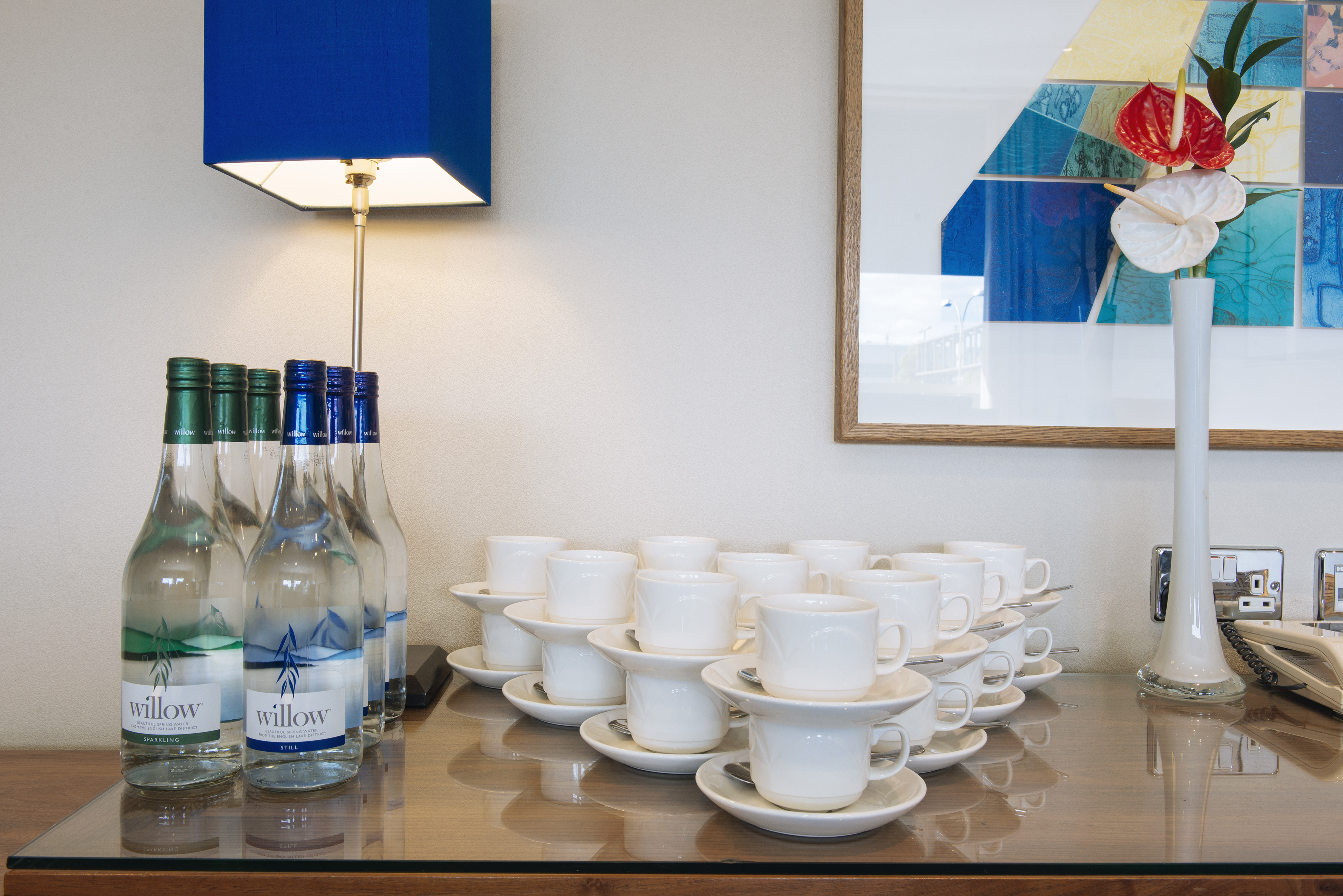 Refreshment station with water bottles and cups at Sofitel London Gatwick meeting event.
