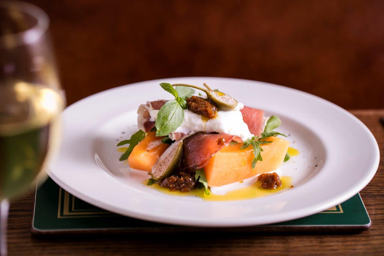 Cantaloupe, prosciutto, and burrata dish at Banana Vault for events in Covent Garden.