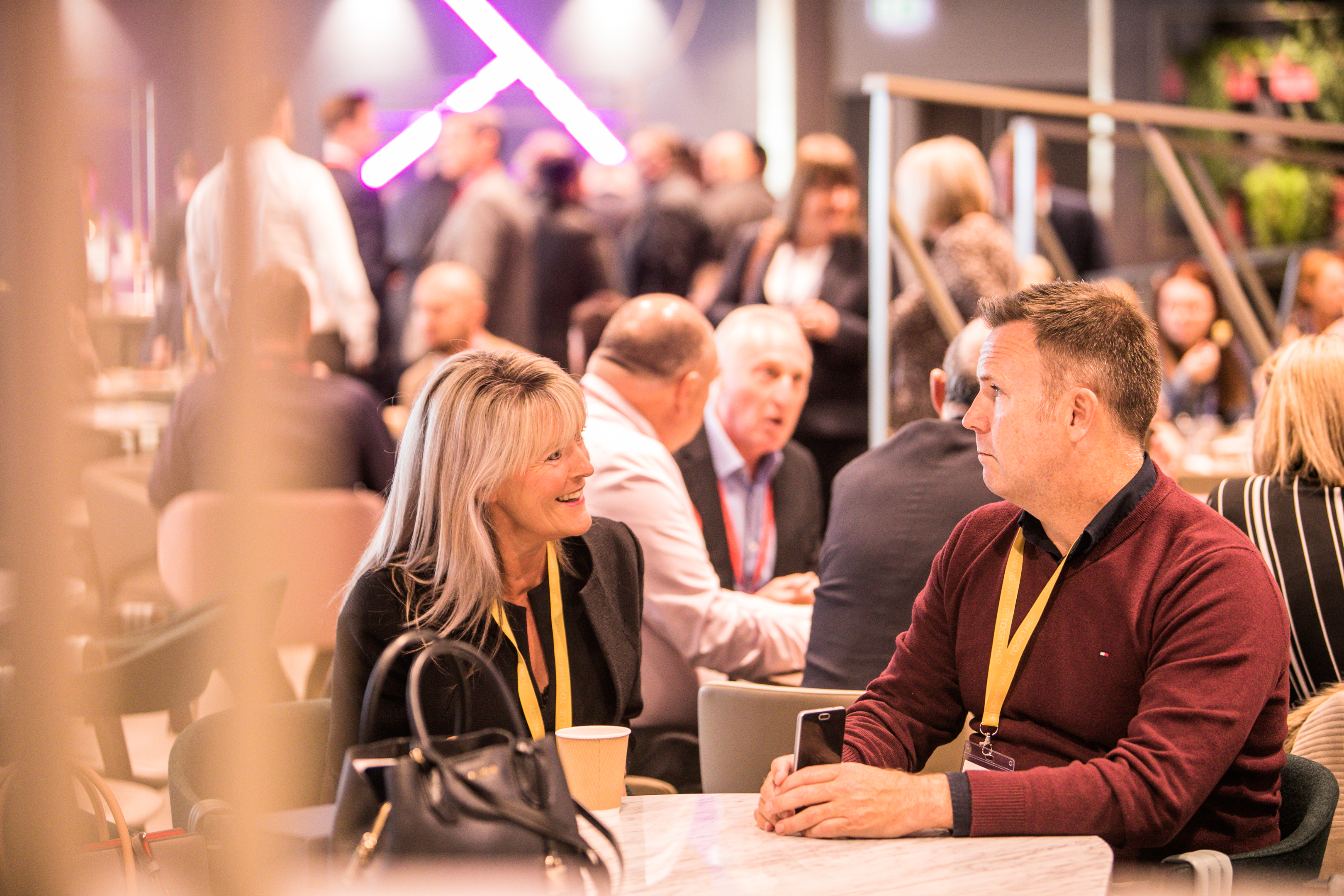 Vibrant networking event in The Atrium, Wembley Stadium with modern decor and engaged attendees.