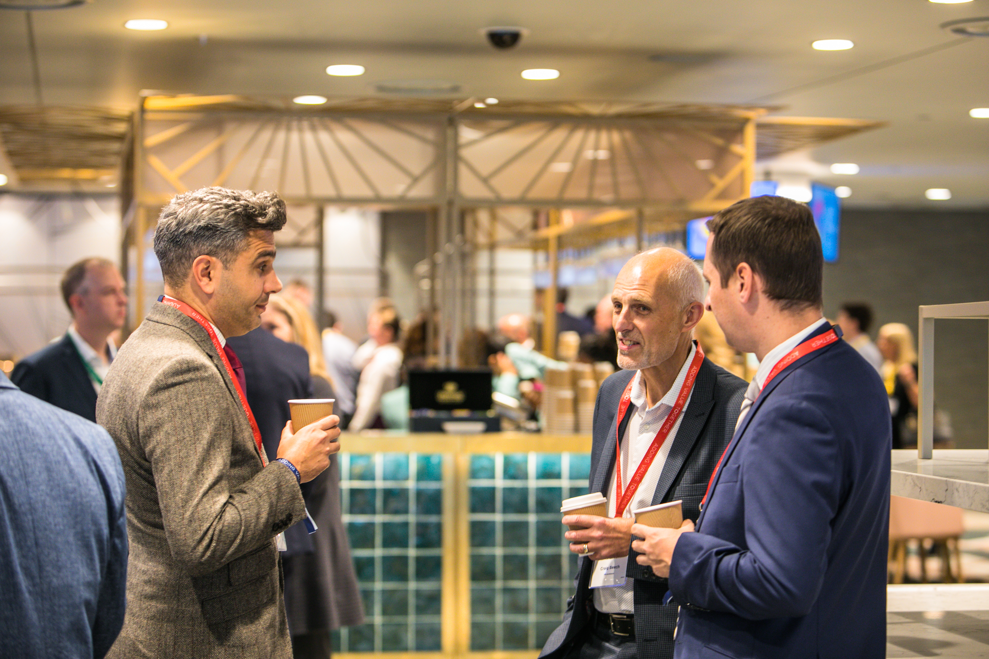 Networking event in The Atrium, Wembley Stadium; modern setting with attendees engaged.