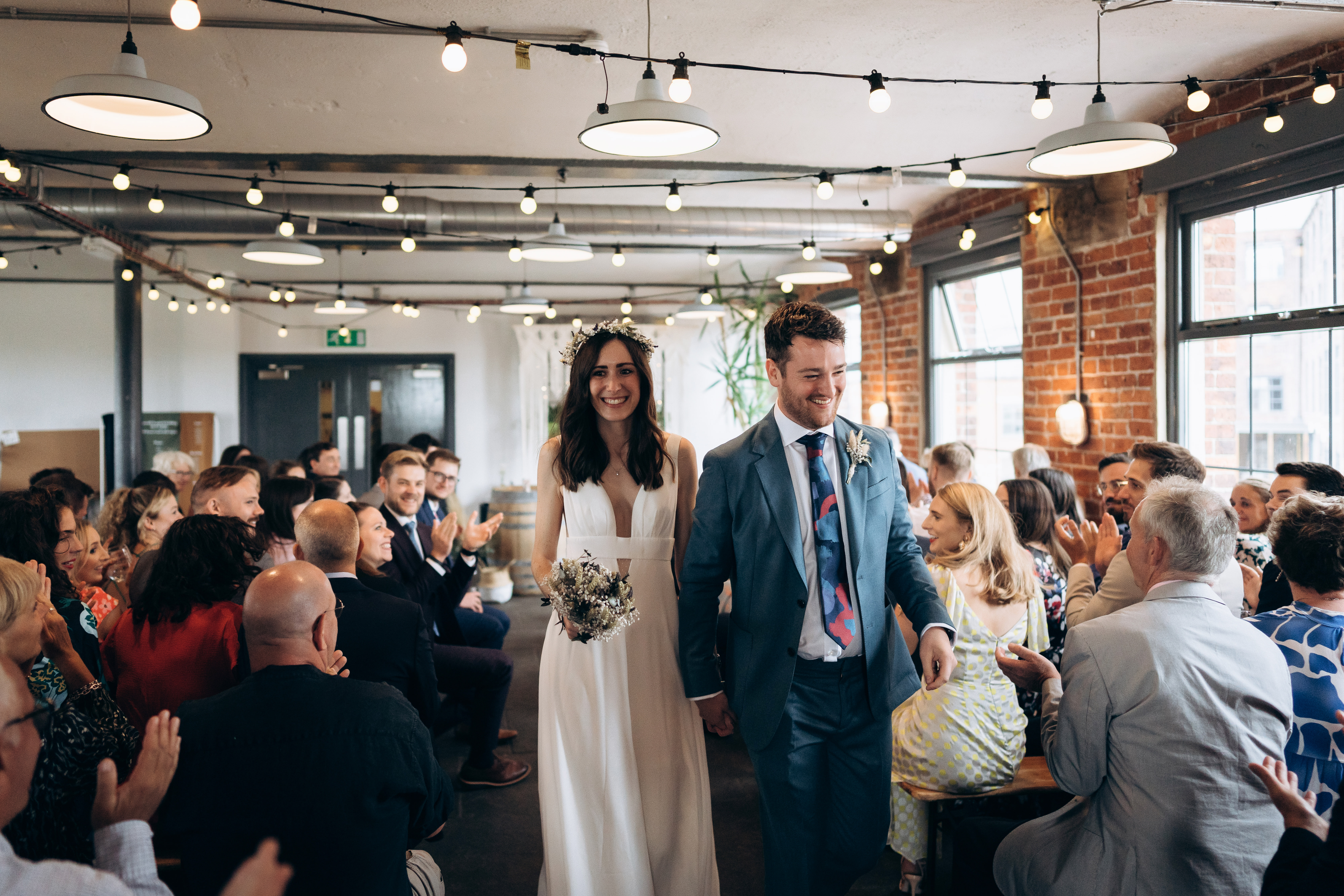 Joyful wedding ceremony in The Chapter Hall with warm lighting and rustic decor.