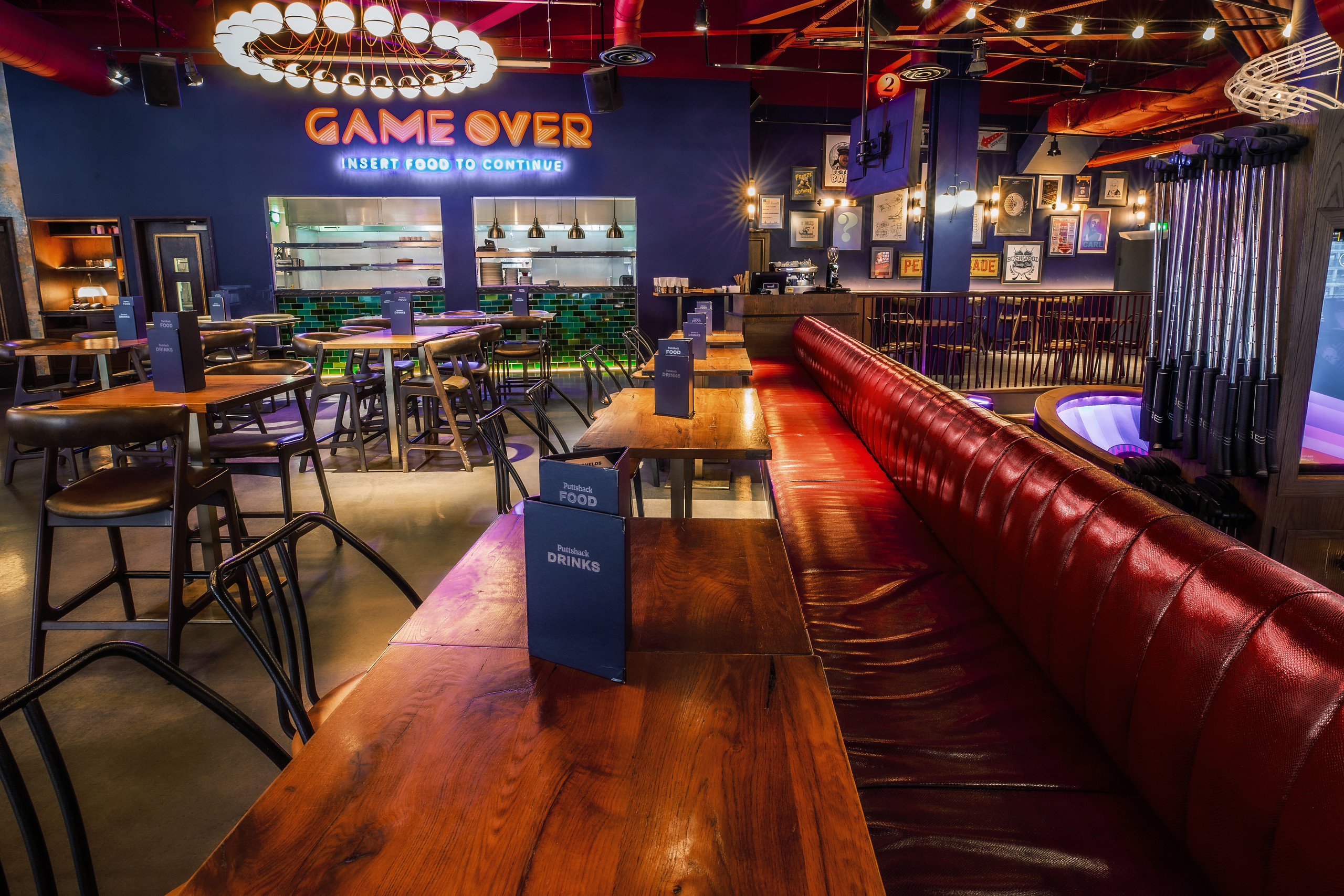 Vibrant Ruby Area at Puttshack White City, ideal for team-building and casual gatherings.