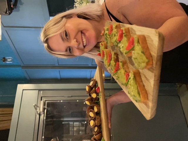 Vibrant catering setup at The Tokenhouse with appetizers and enthusiastic staff.