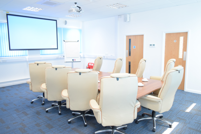 Executive meeting room with large table, ideal for professional gatherings and events.