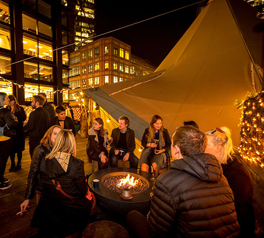 Rooftop event space at Queen of Hoxton with fire pit, perfect for networking and socializing.
