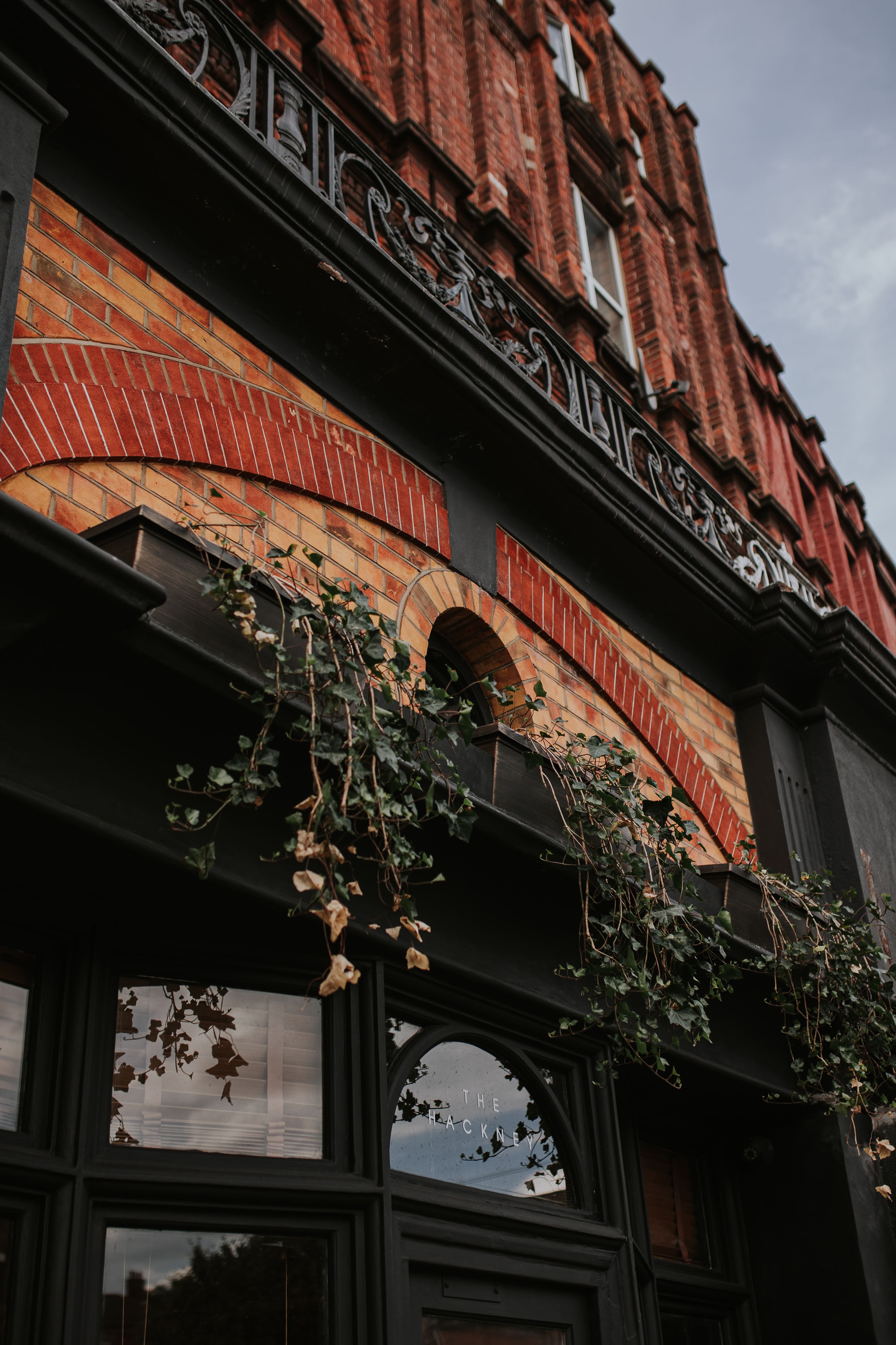 Charming brickwork venue with vines, perfect for events and gatherings.