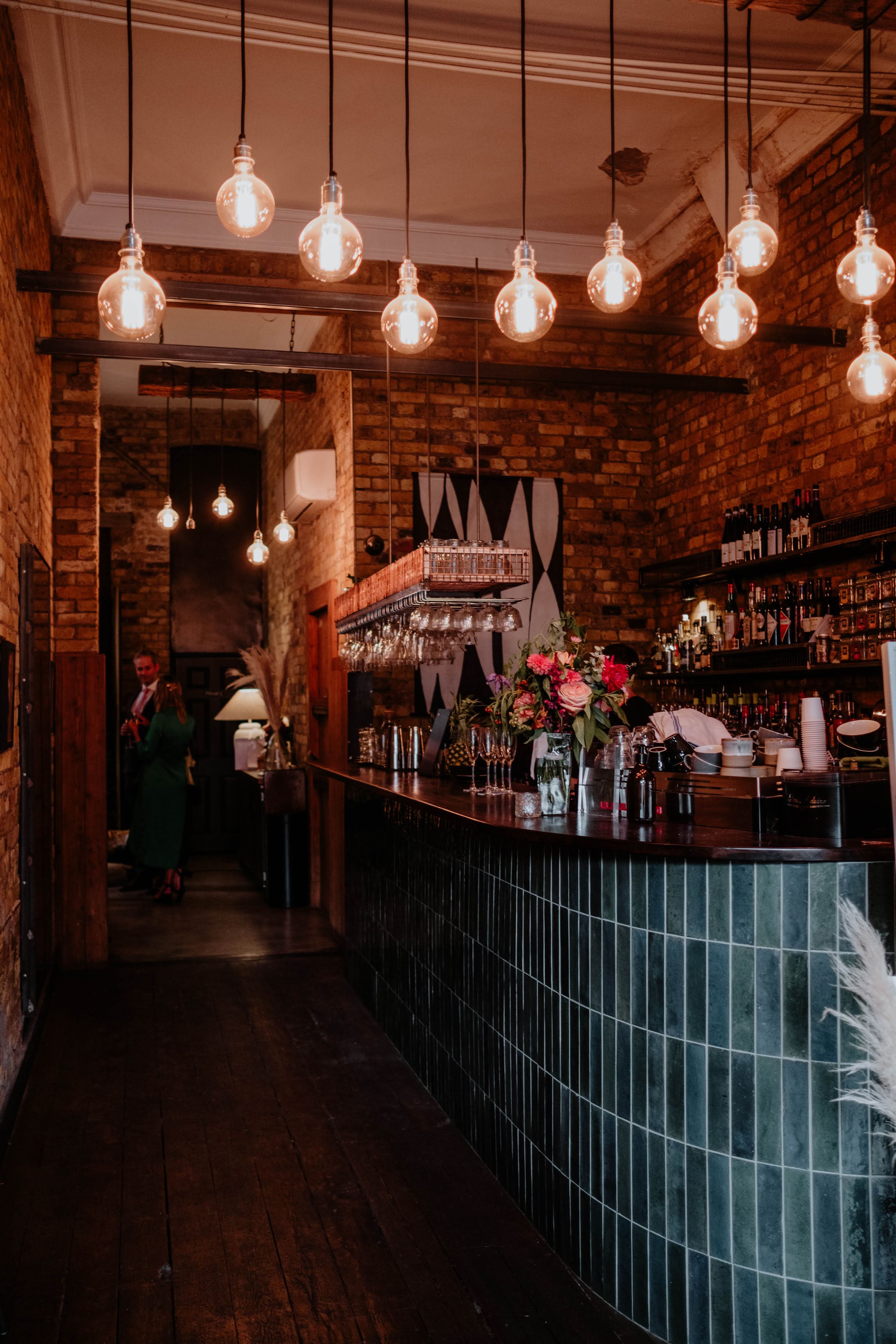 Stylish bar area with warm lighting for intimate gatherings and networking events.