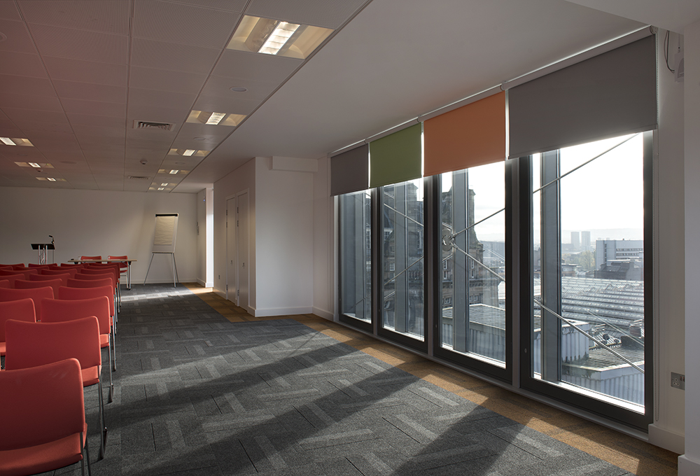 Modern meeting space in Glasgow with large windows, ideal for workshops and presentations.