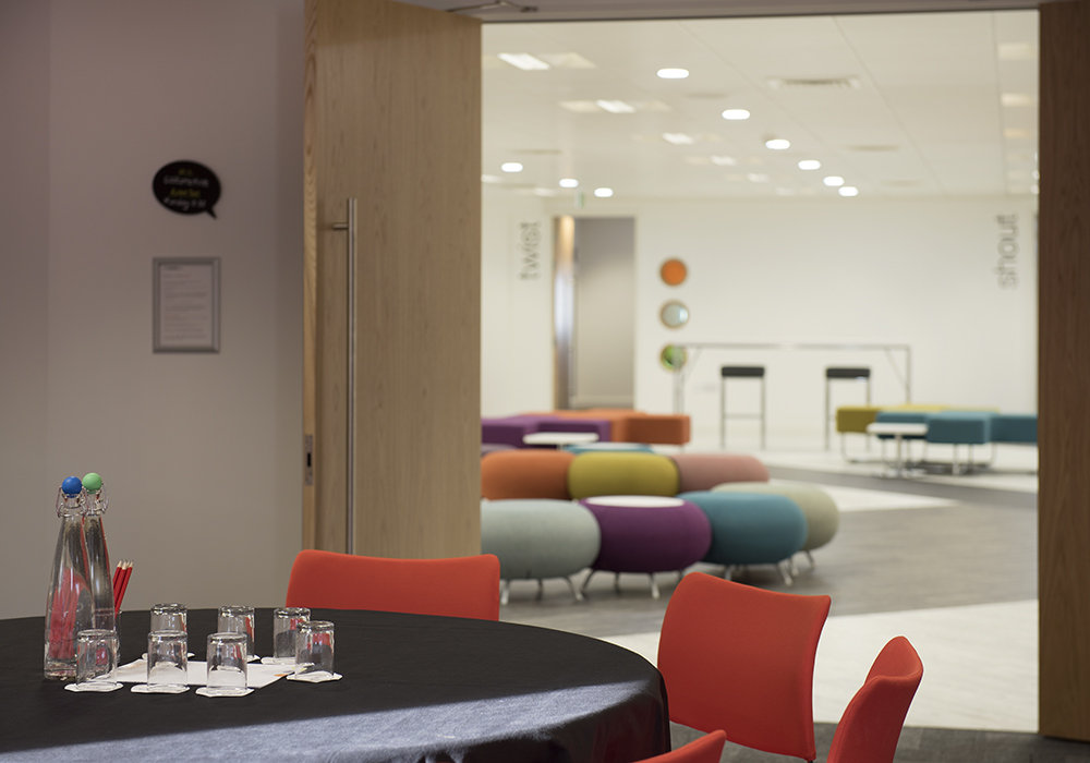 Modern meeting space in Glasgow with round table for collaboration and creativity.
