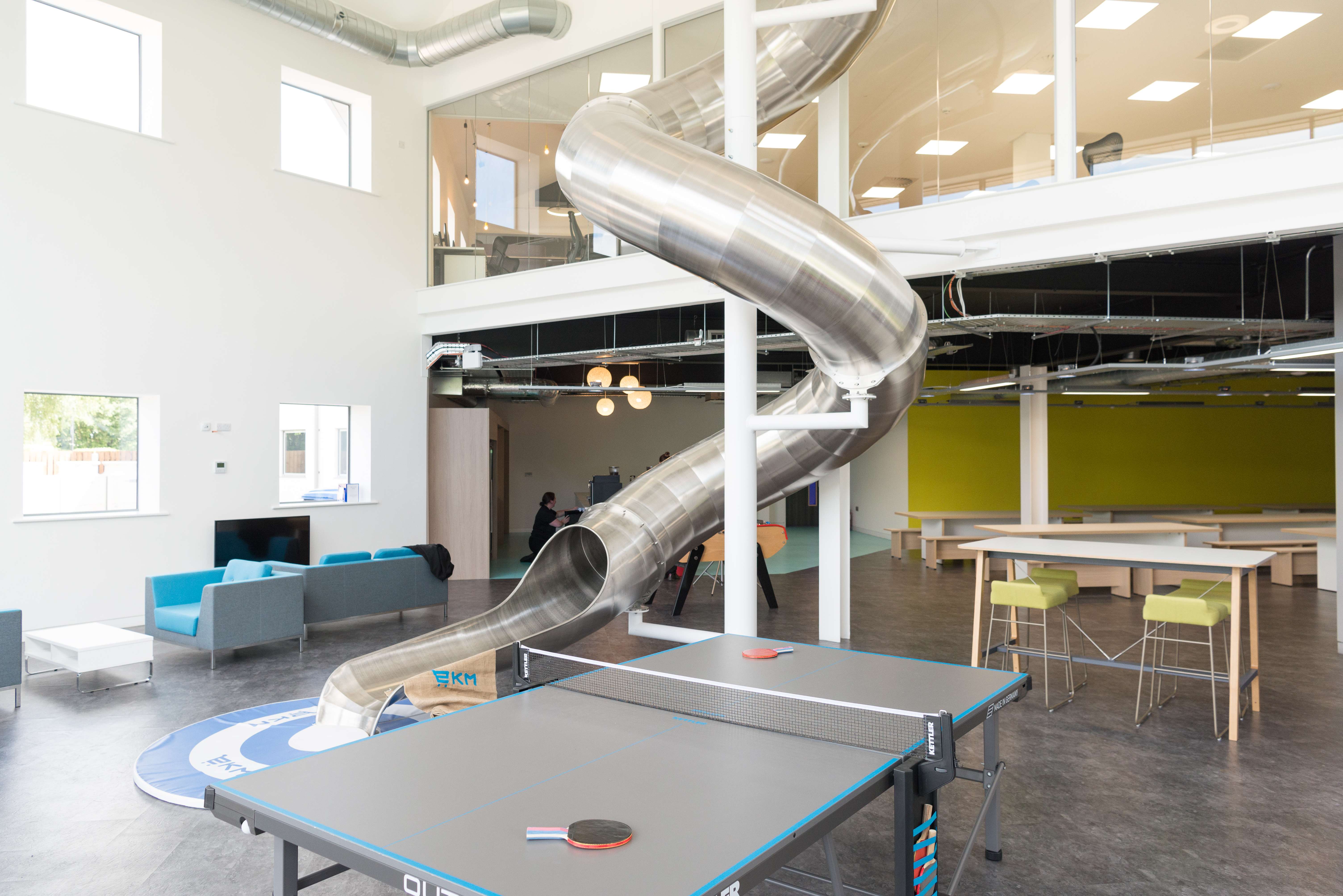 Modern auditorium with playful slide for creative meetings and team-building events.