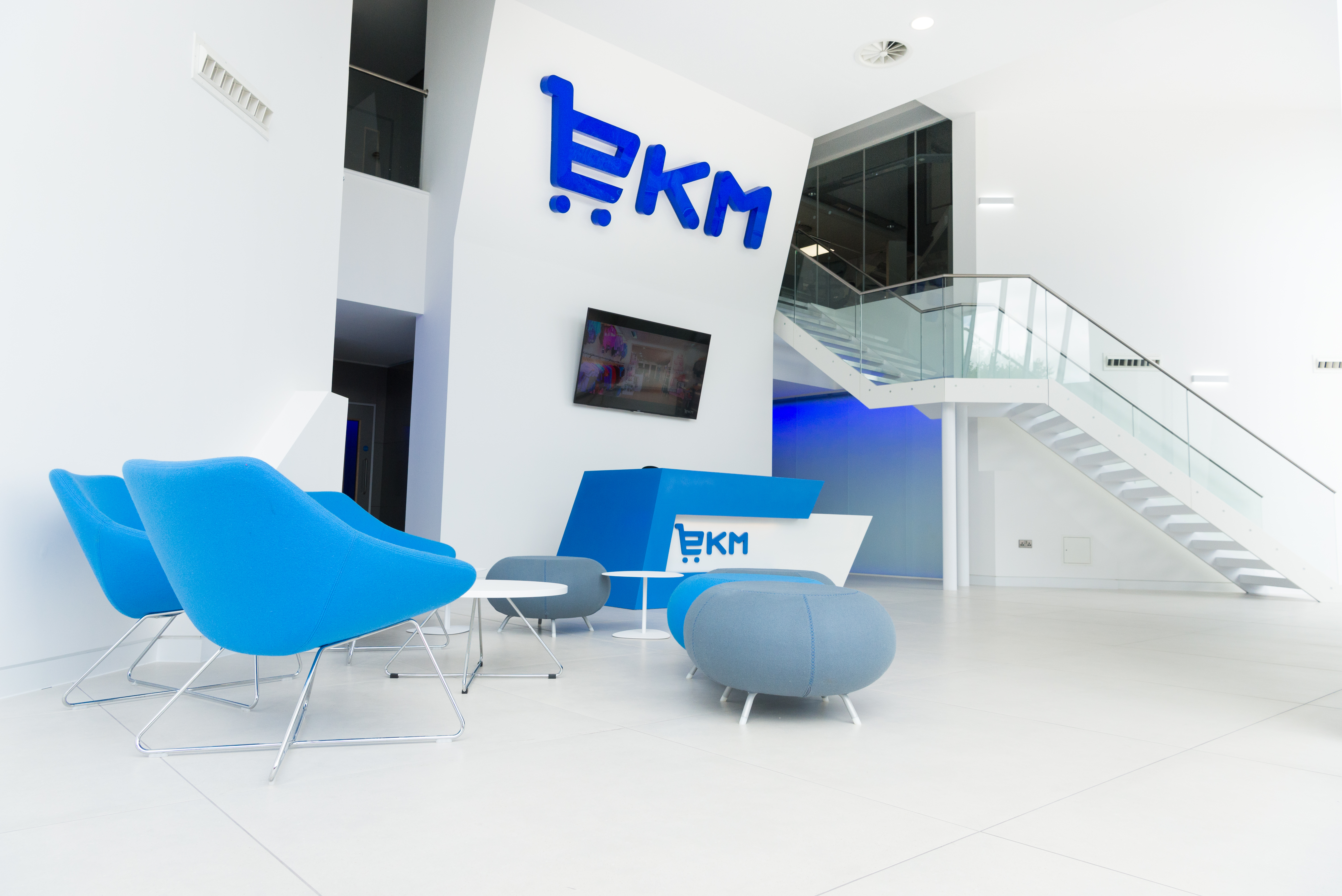 Modern board room with blue seating, ideal for meetings and events.