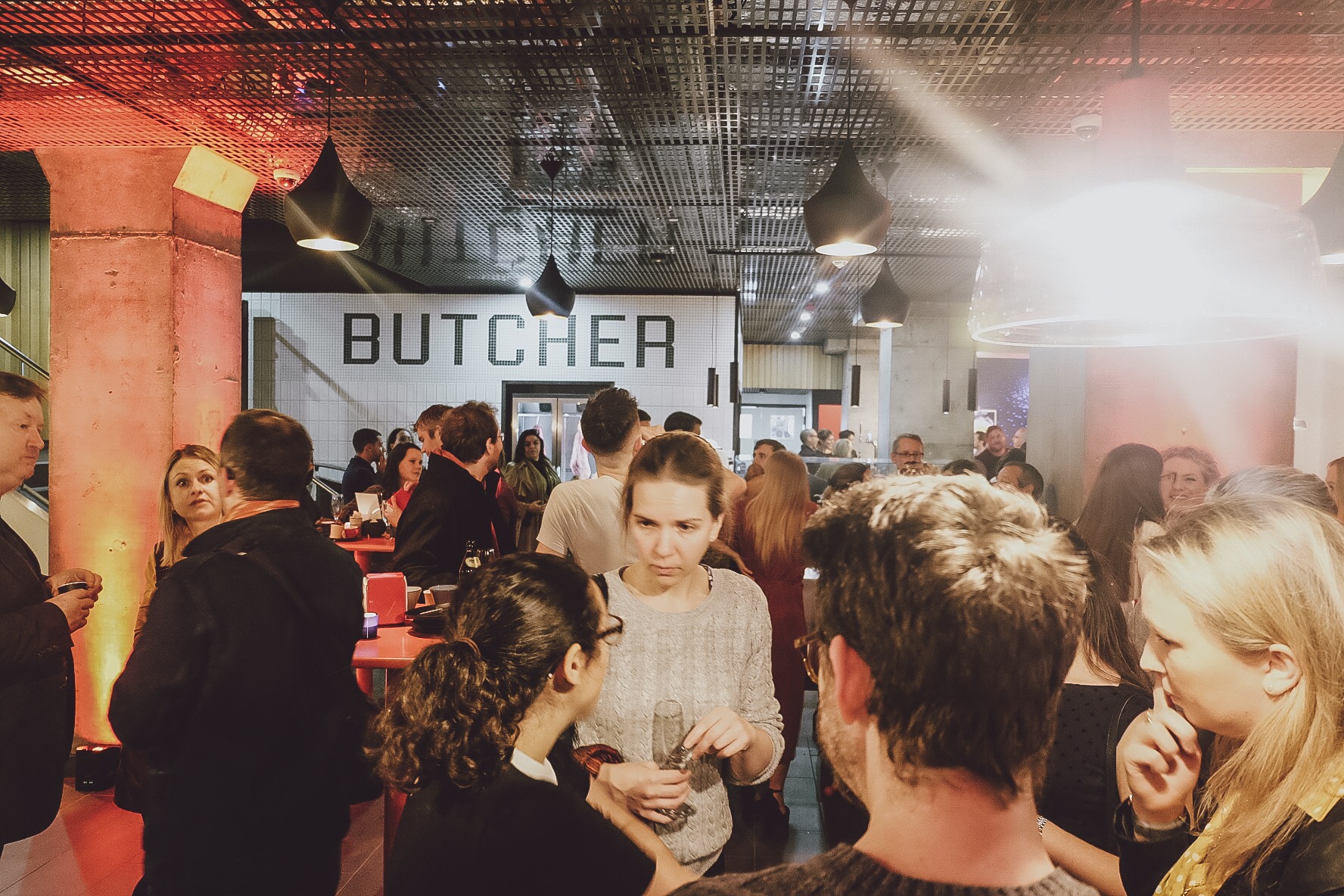 Vibrant networking event at modern venue with stylish decor and engaged attendees.