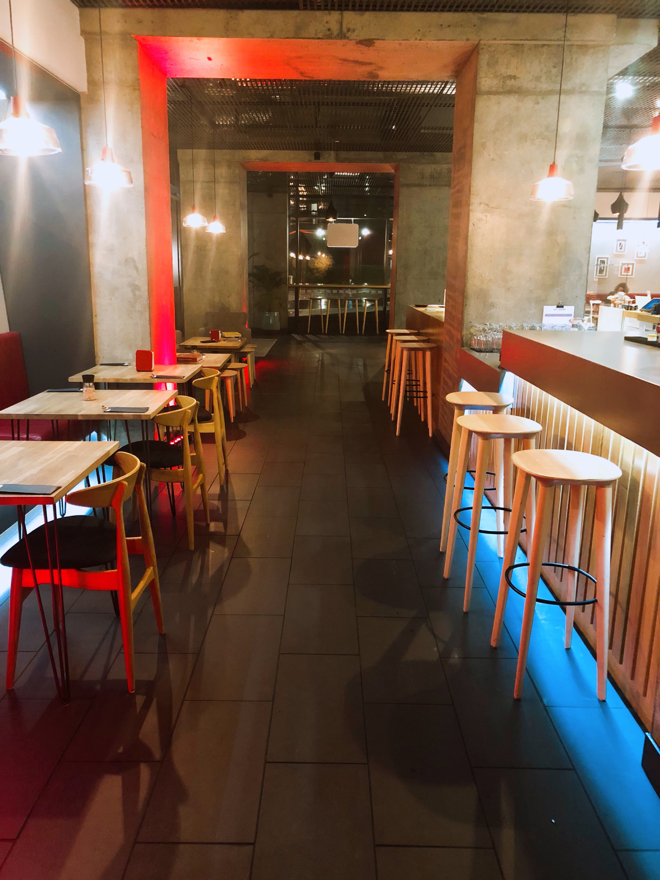 Modern minimalist venue with sleek bar, perfect for networking events and casual meetings.