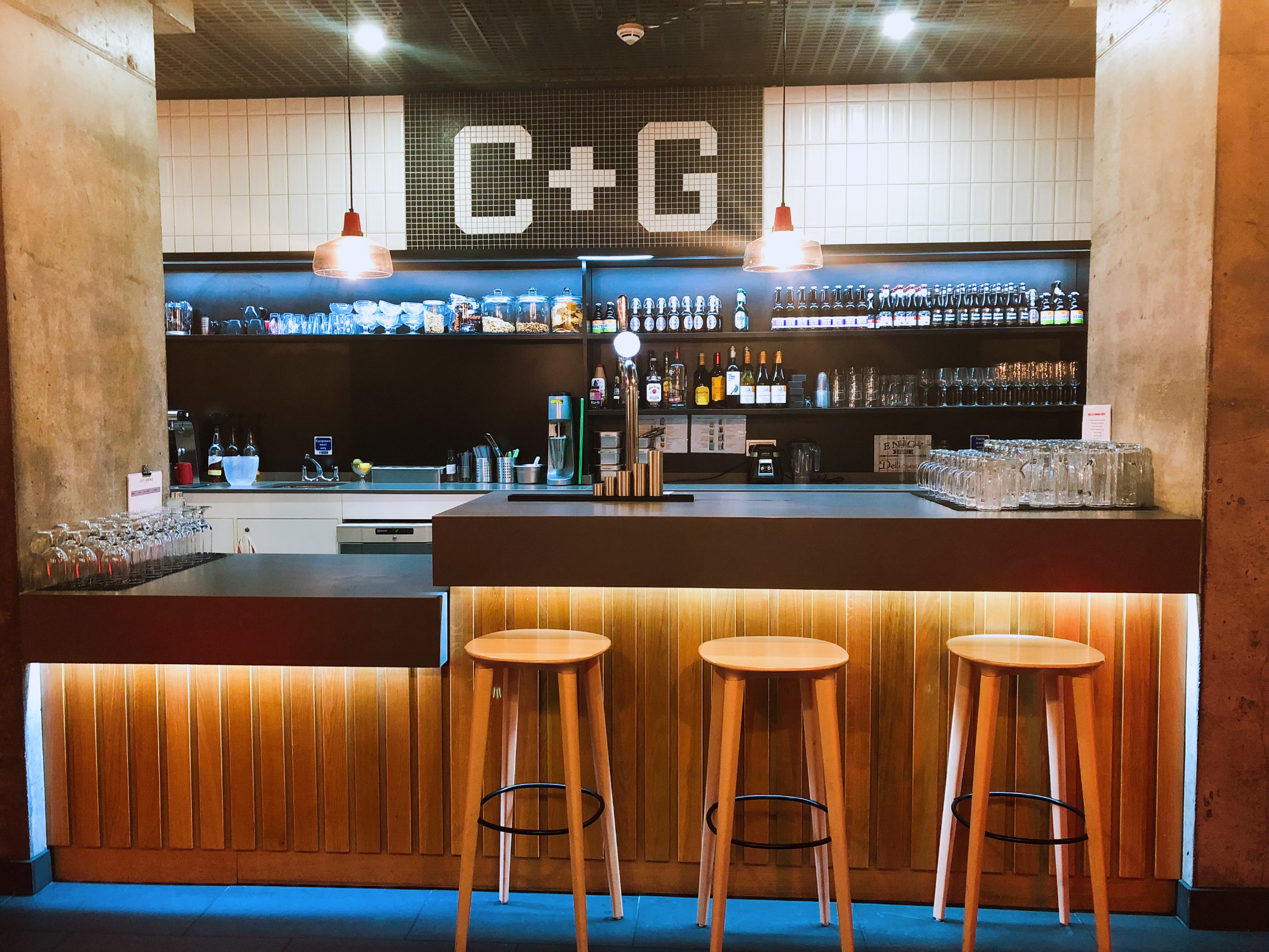 Sleek bar area in Cut and Grind, perfect for networking events and casual gatherings.