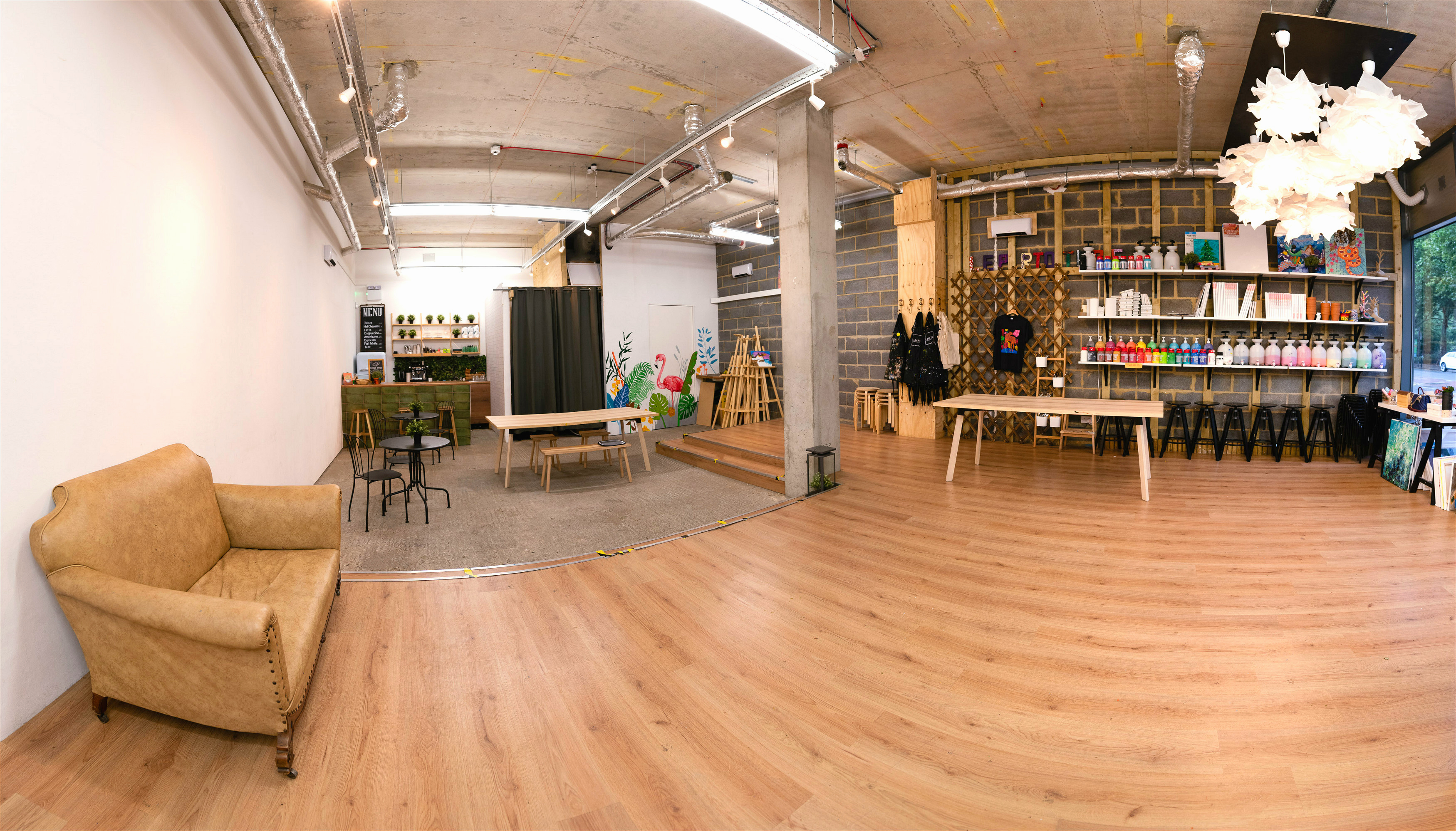 Versatile event space in Studio 249 with warm wooden flooring for workshops and networking.