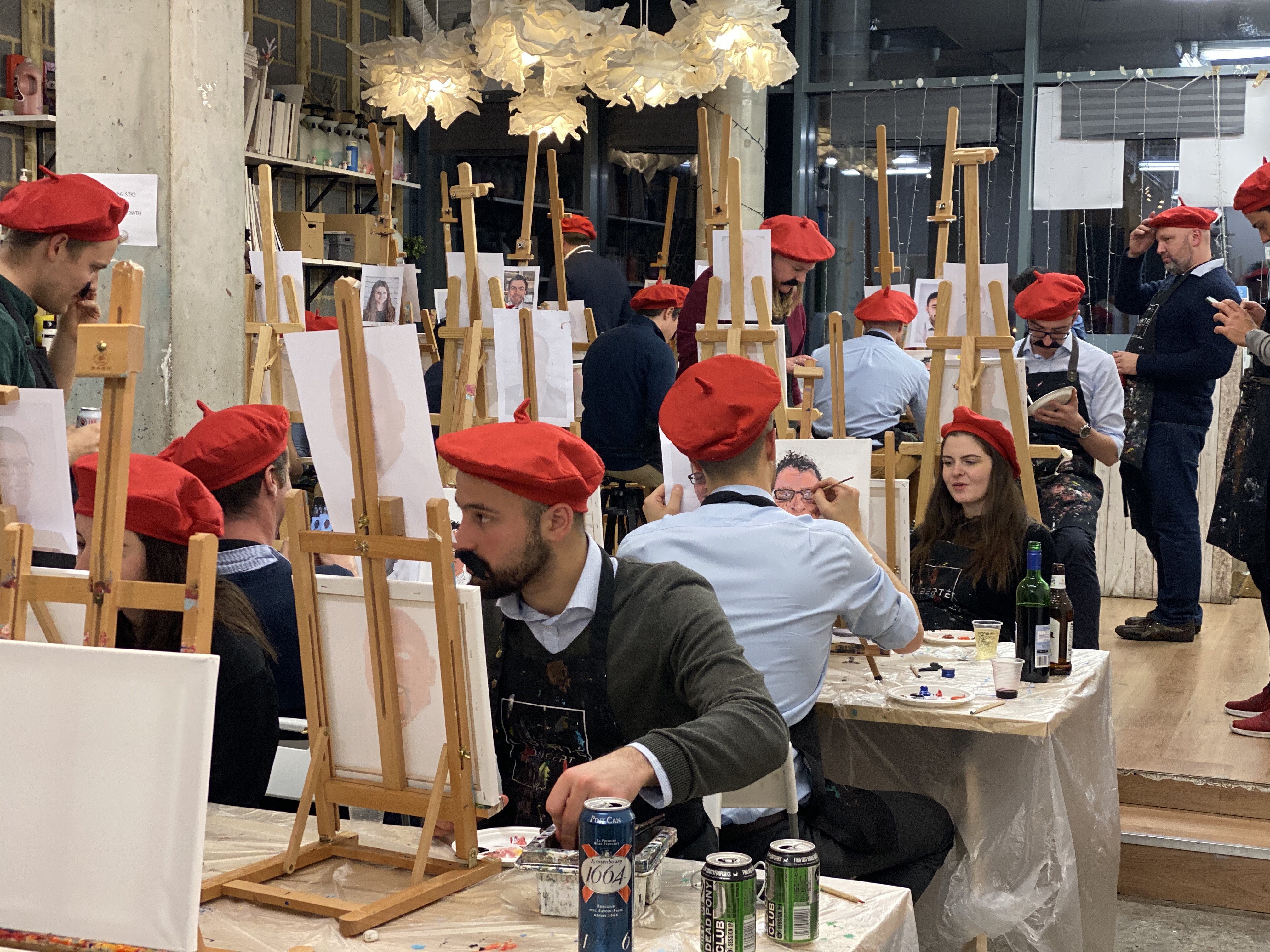 Vibrant group painting event at Studio 249 with participants in red berets.