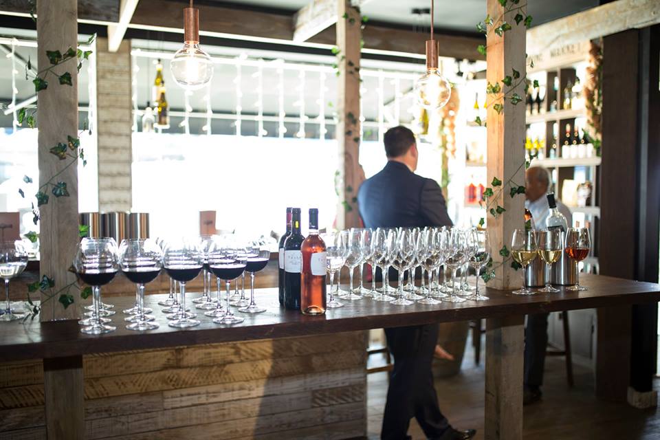 Elegant bar setup with glassware for networking event at Veeno Italian Wine Bar.