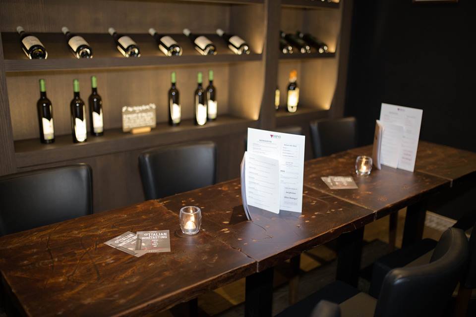Sophisticated meeting space with wooden table for corporate events and wine tastings.