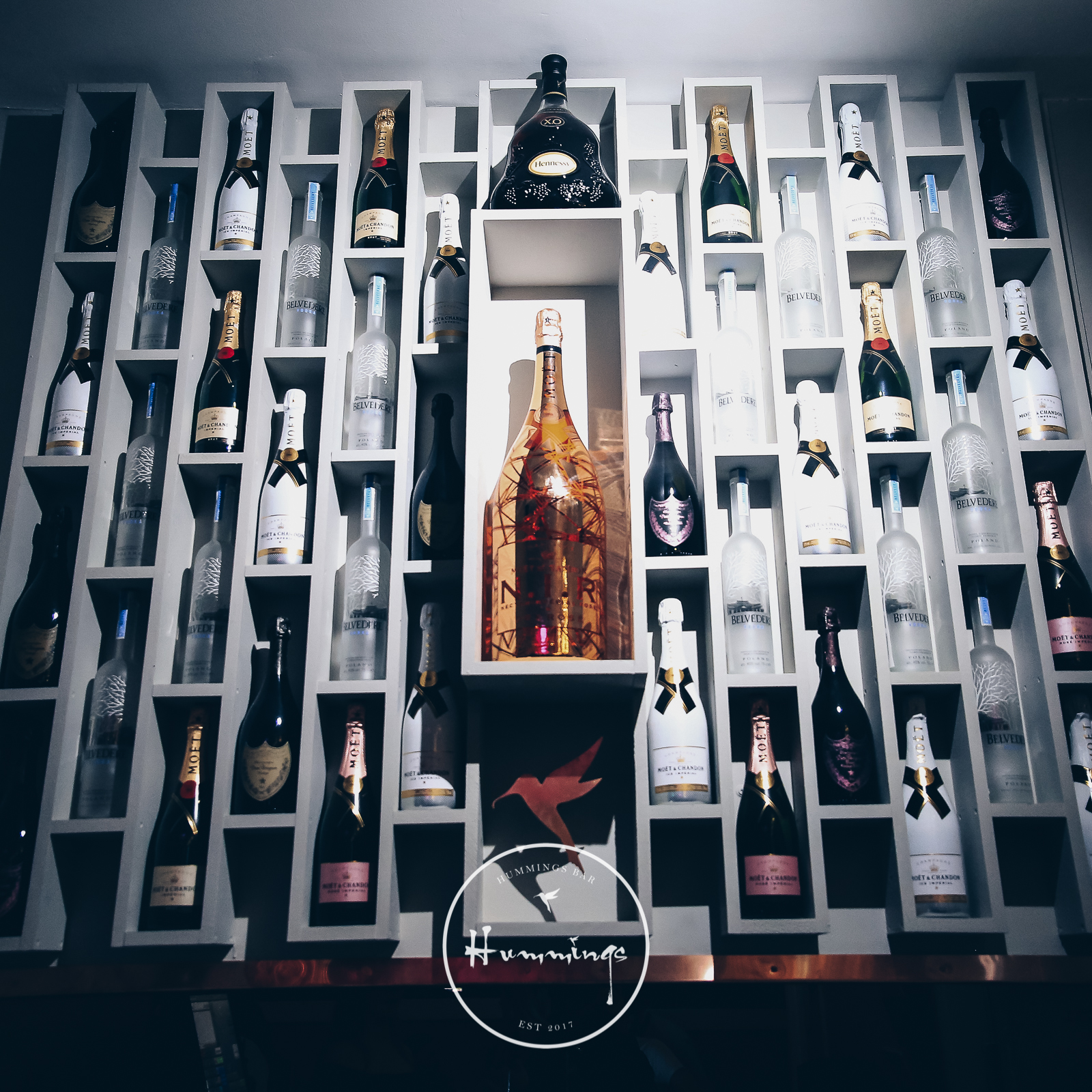 Upscale venue with elegant wine display, perfect for receptions and celebrations.