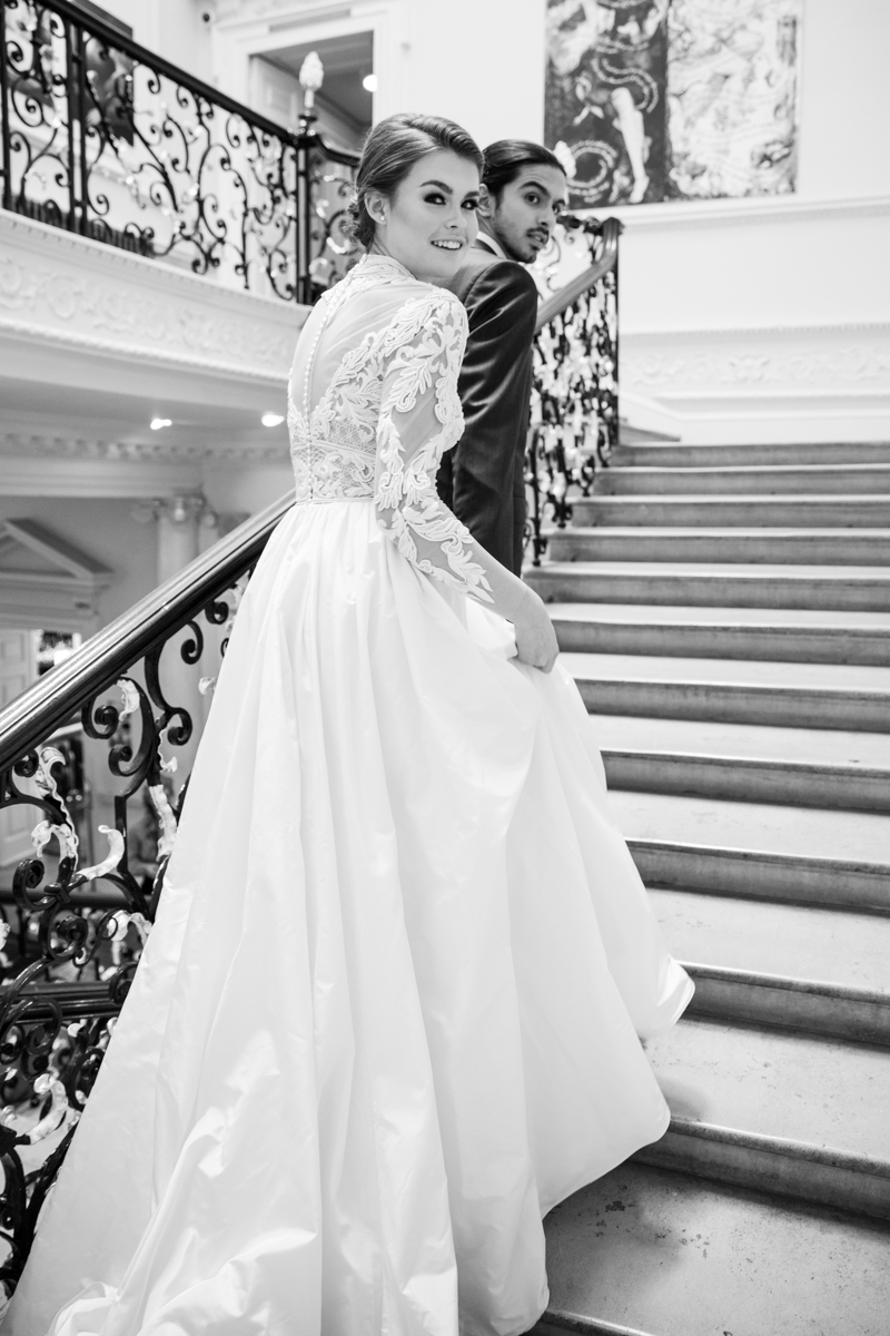 Stylish couple on elegant staircase at Weddings in Six Park Place, perfect for upscale events.