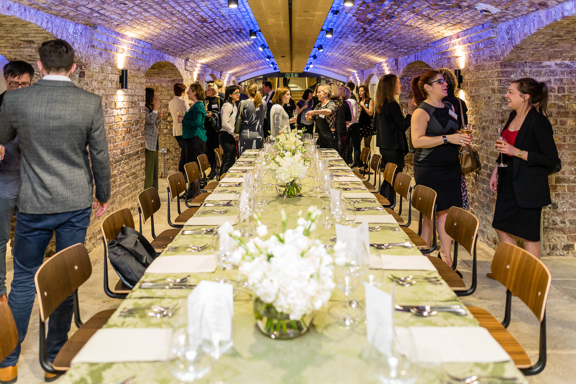 London Bridge Arches event space with elegant floral centerpieces for corporate dinners.