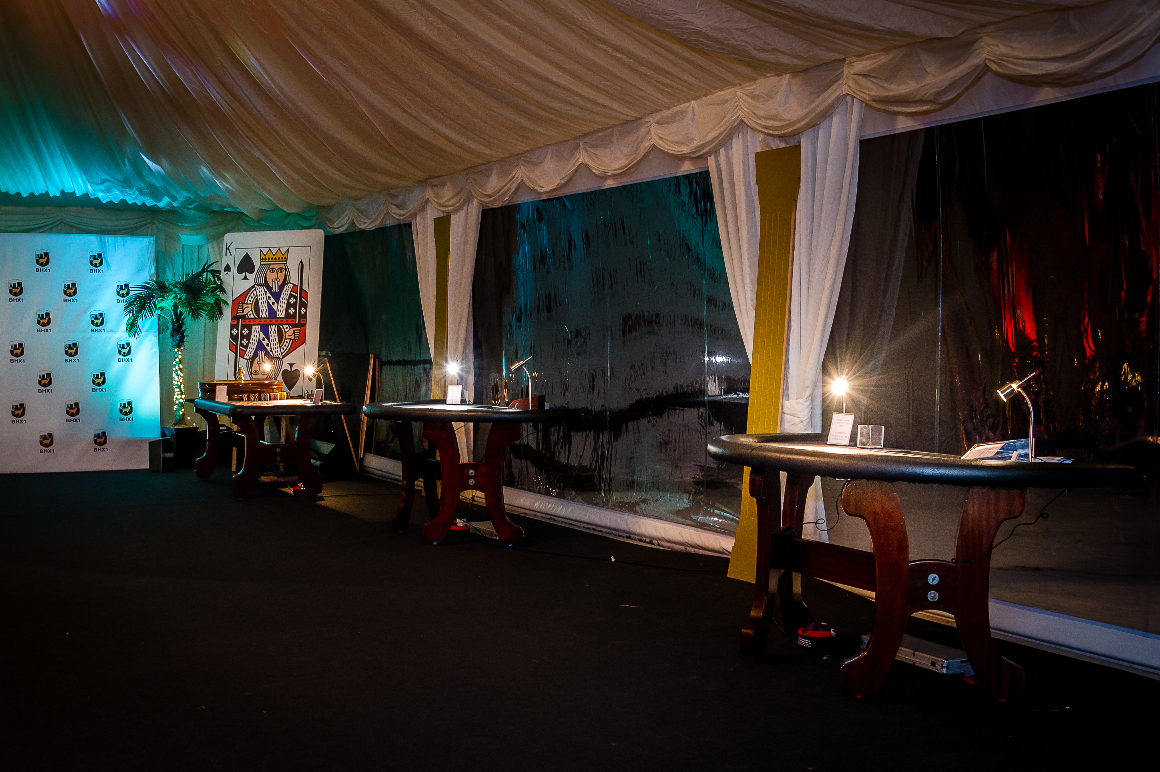 Elegant event space in Hilton Hall with draped tent and focused lighting for networking.