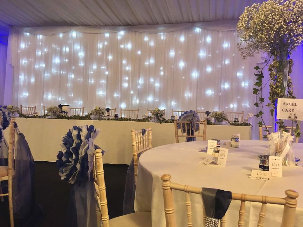 Elegant Hilton Hall marquee with twinkling lights, perfect for weddings and formal events.