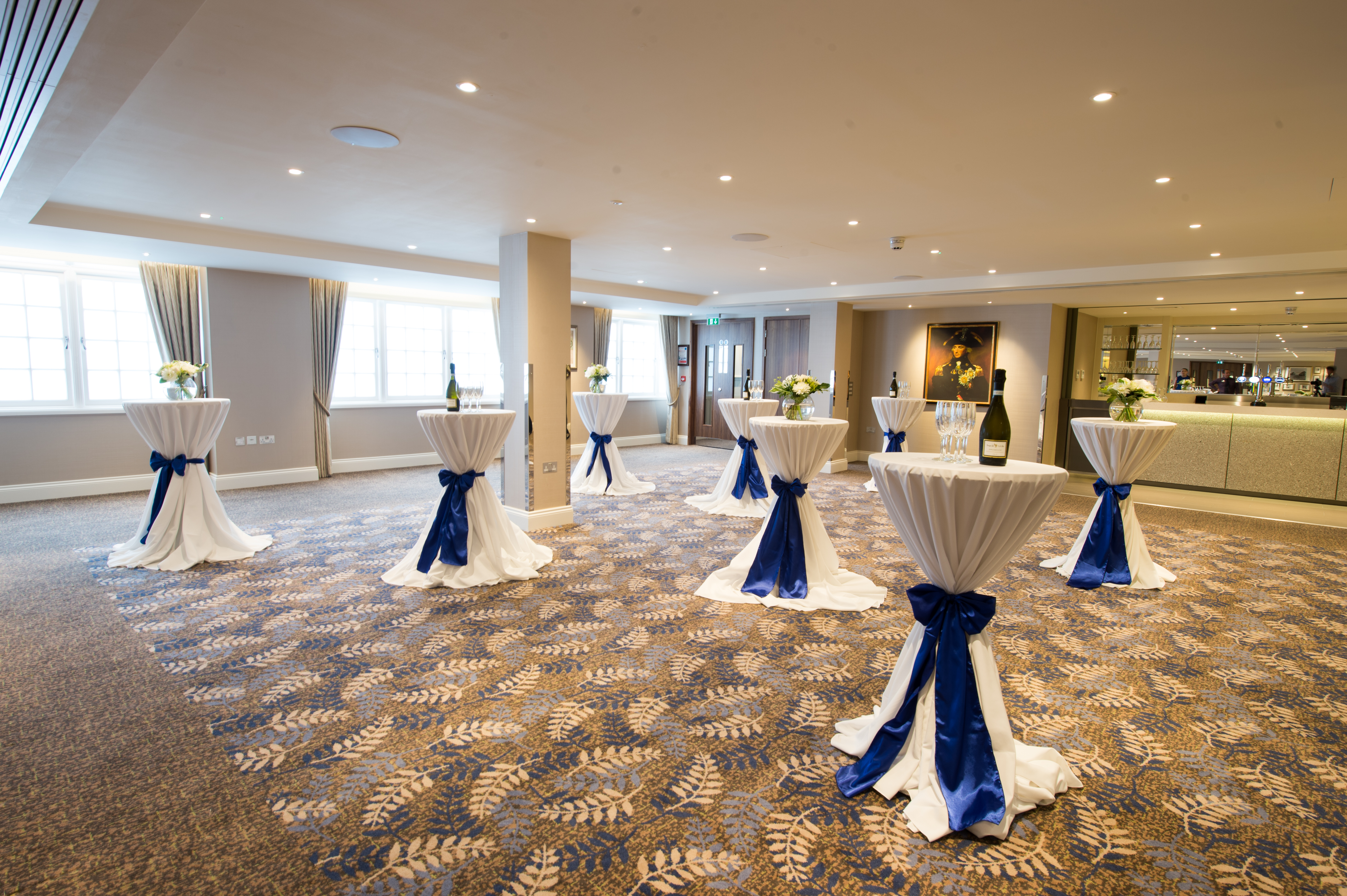 Trafalgar Room at Victory Services Club, elegant reception space with blue bow tables.