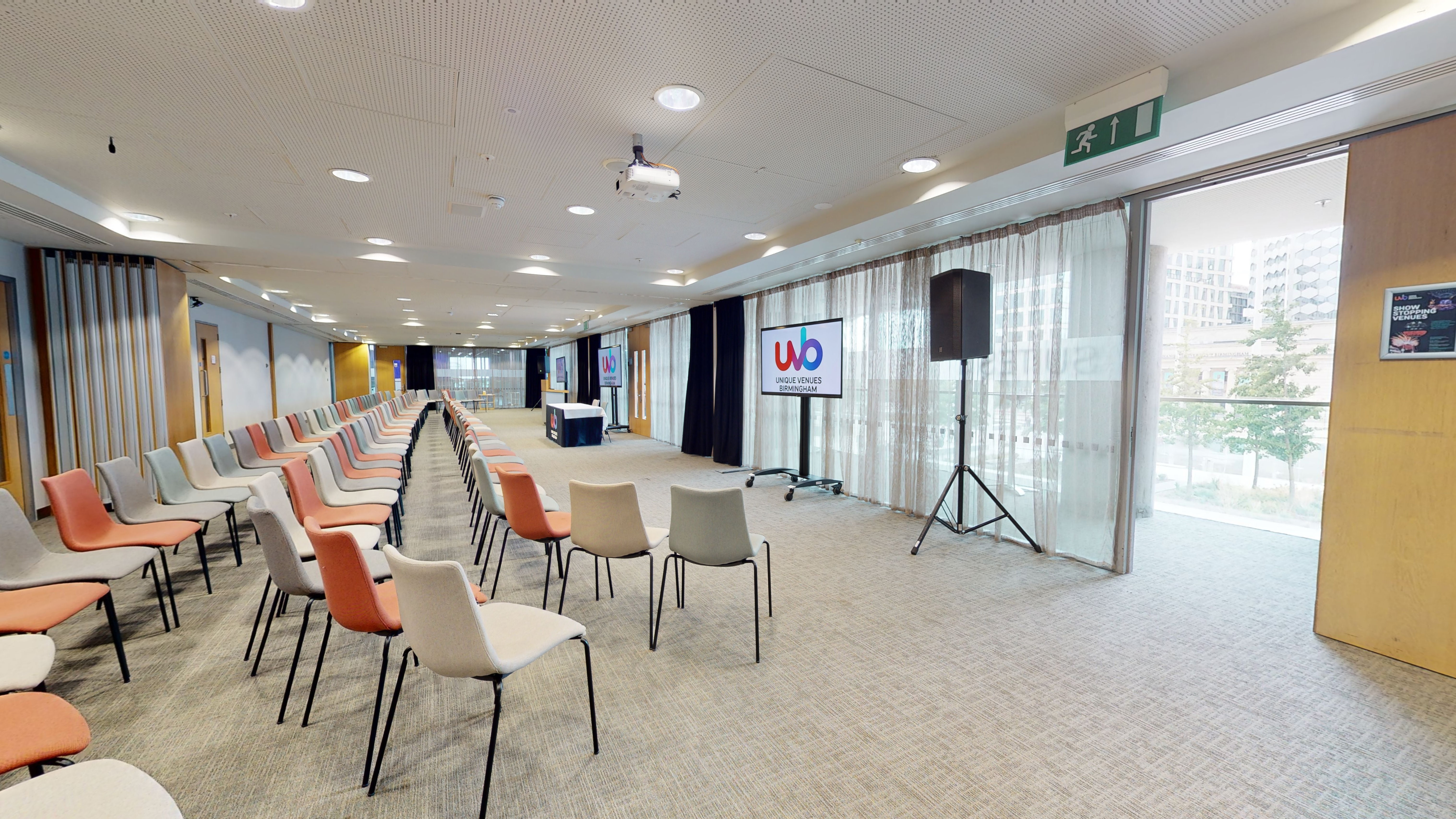 Modern event space with chairs and screen for presentations in Unique Venues Birmingham.