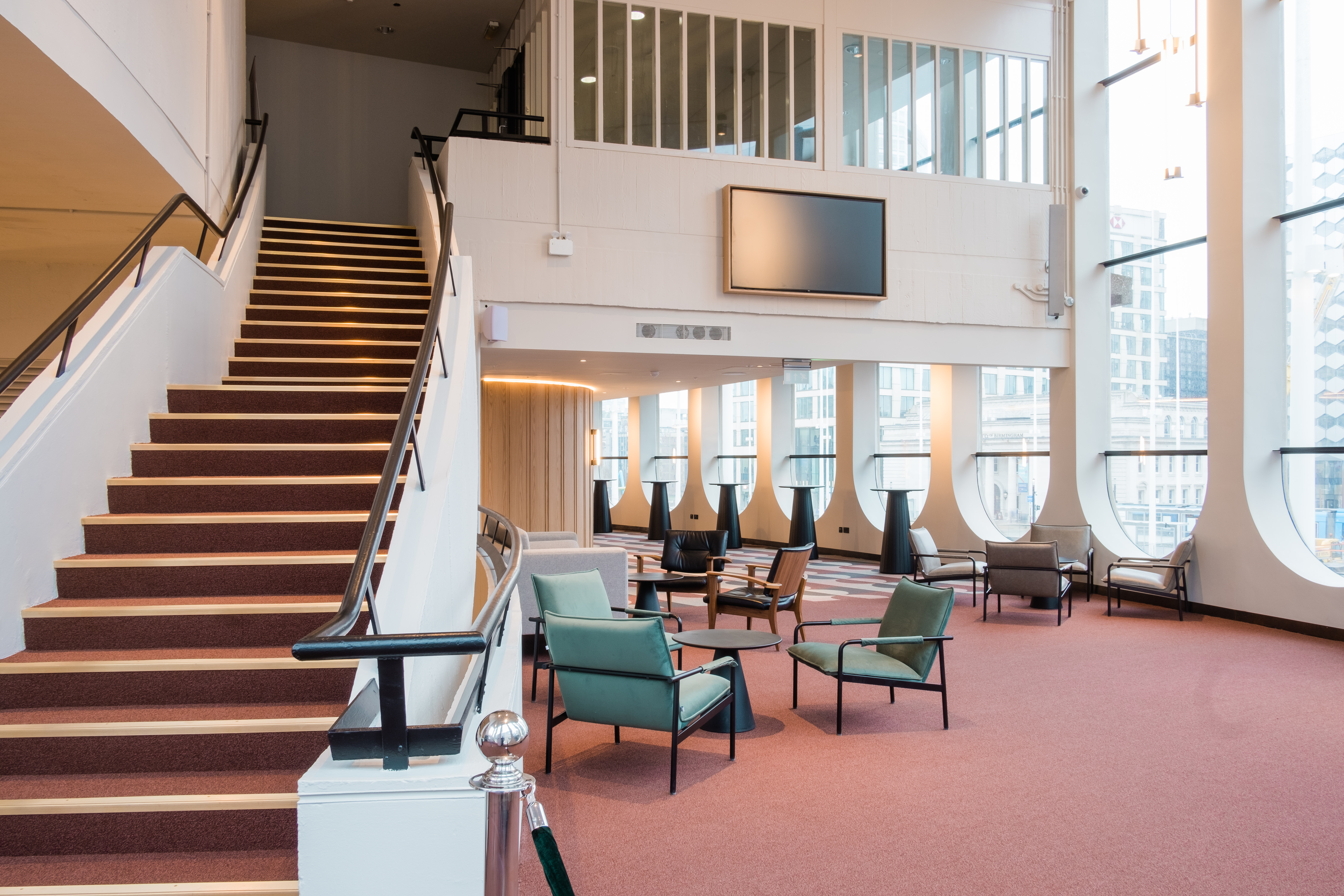 Modern event space in Birmingham with stylish staircase, ideal for meetings and gatherings.
