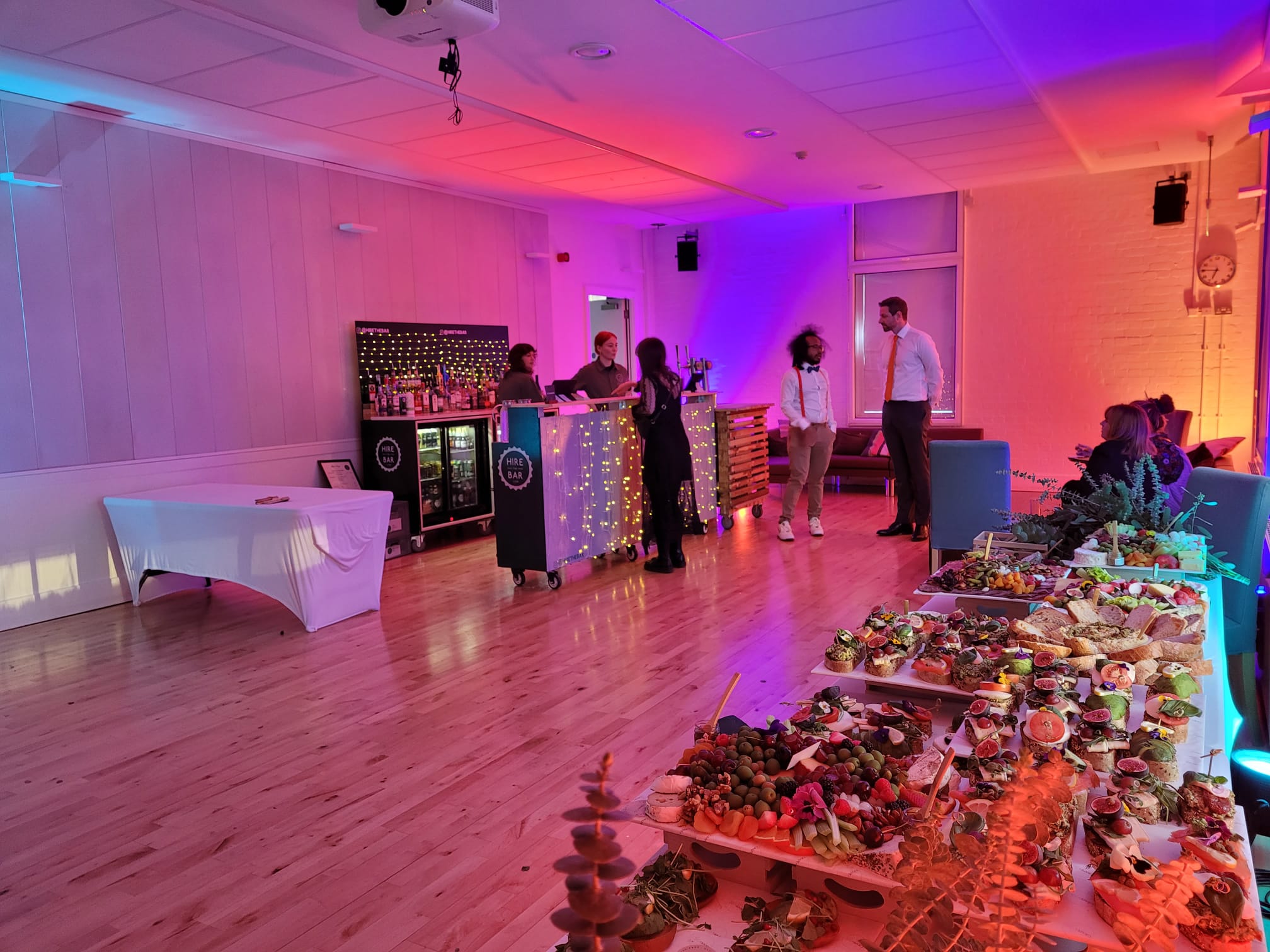 Stylish Research Studio event space with vibrant lighting and gourmet catering setup