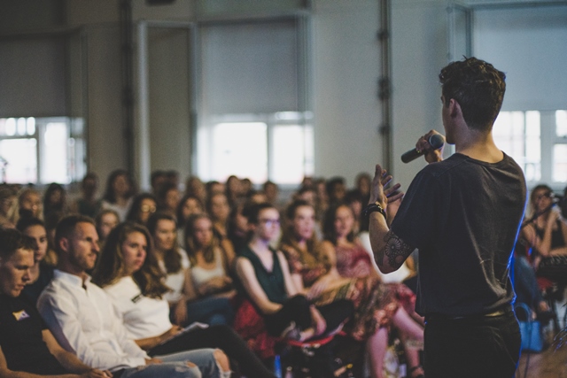 Speaker engaging diverse audience at Siobhan Davies Studios event.