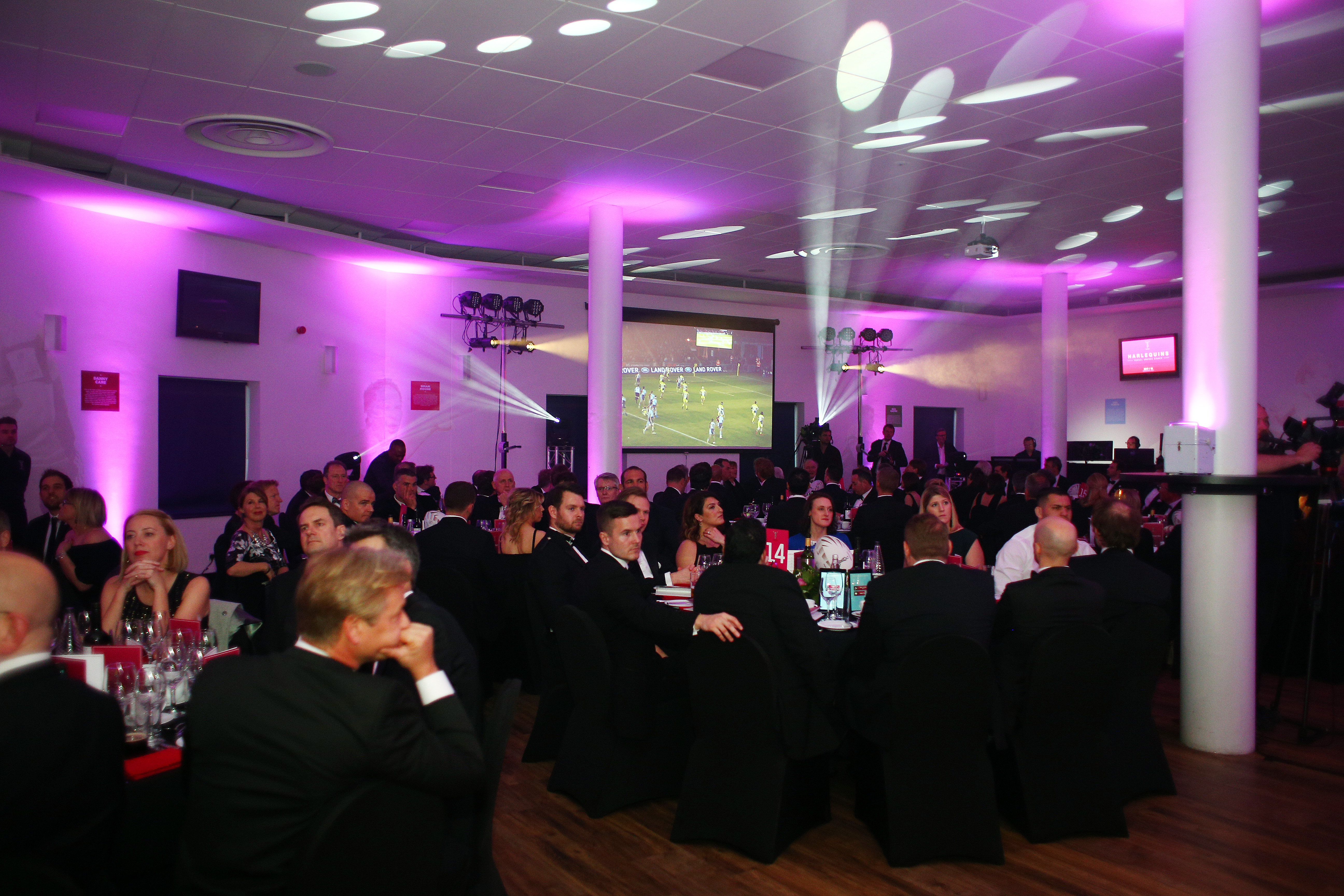 Elegant event setup in Twickenham Stoop with purple lighting for corporate gatherings.