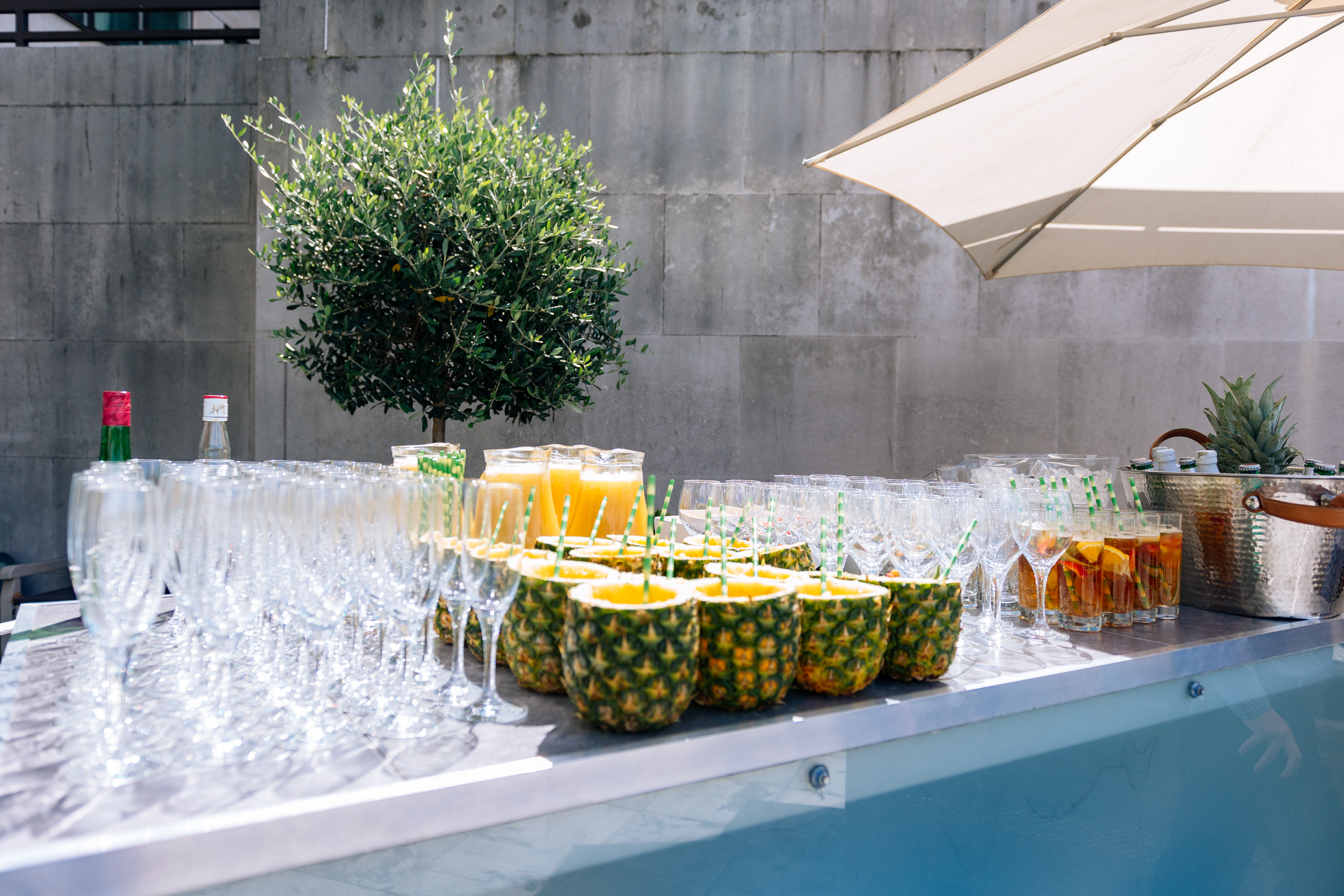 Stylish beverage station with pineapple containers for summer parties and outdoor events.