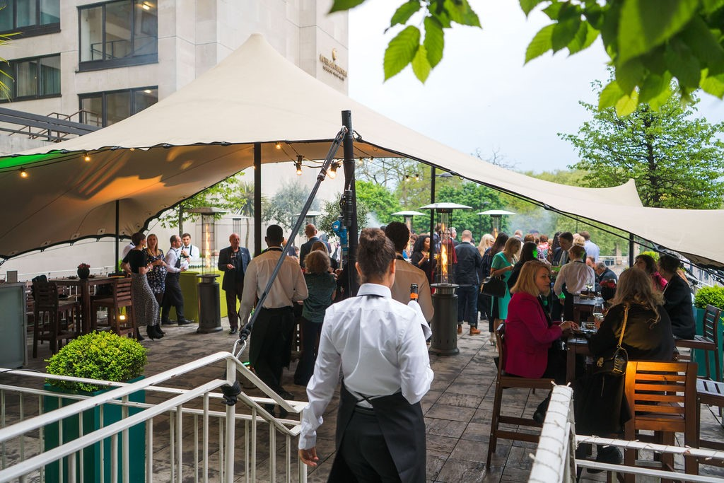 Vibrant outdoor summer party at No. 4 Hamilton Place with stylish seating and networking.