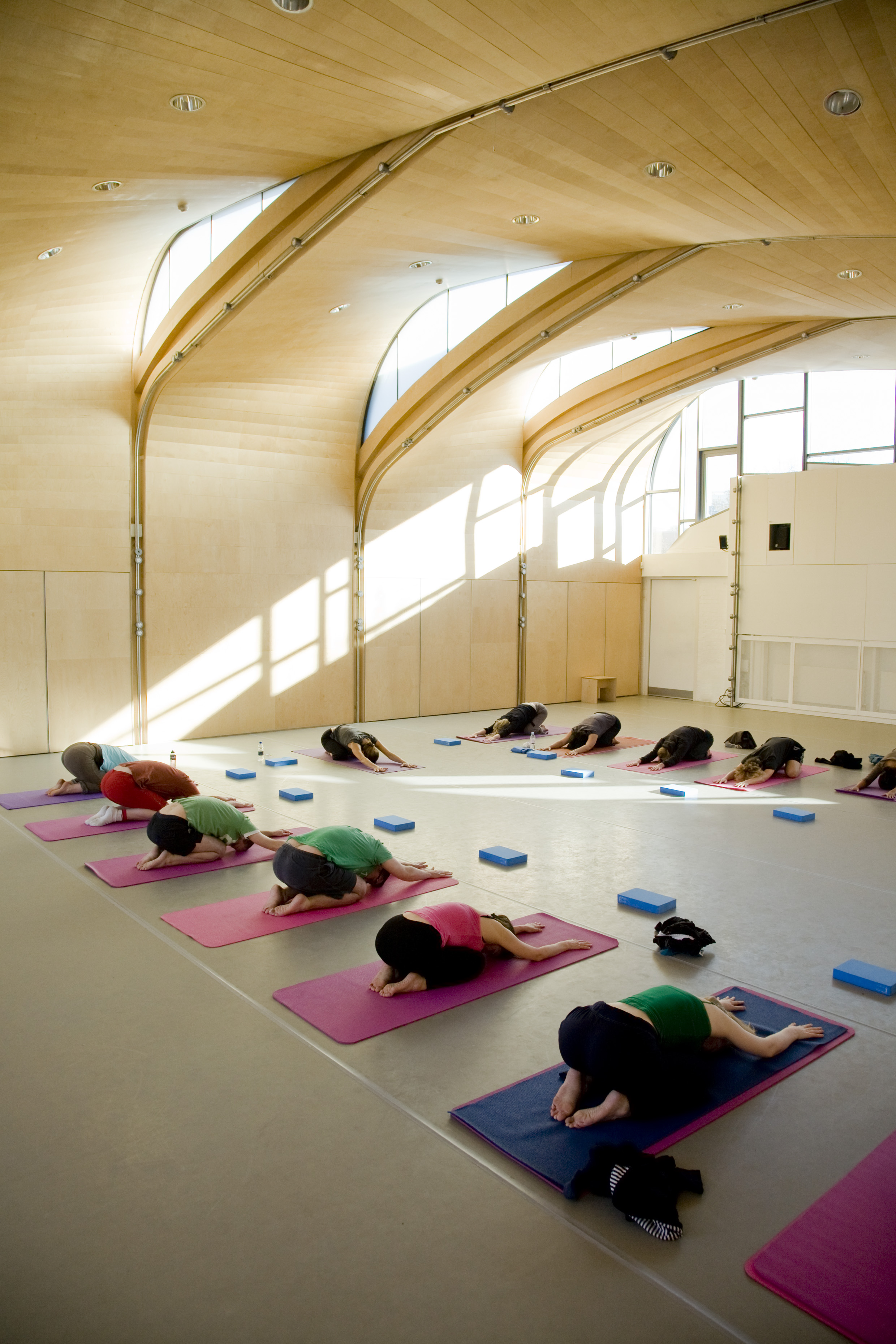 Serene yoga session in airy Siobhan Davies Studios for wellness events.