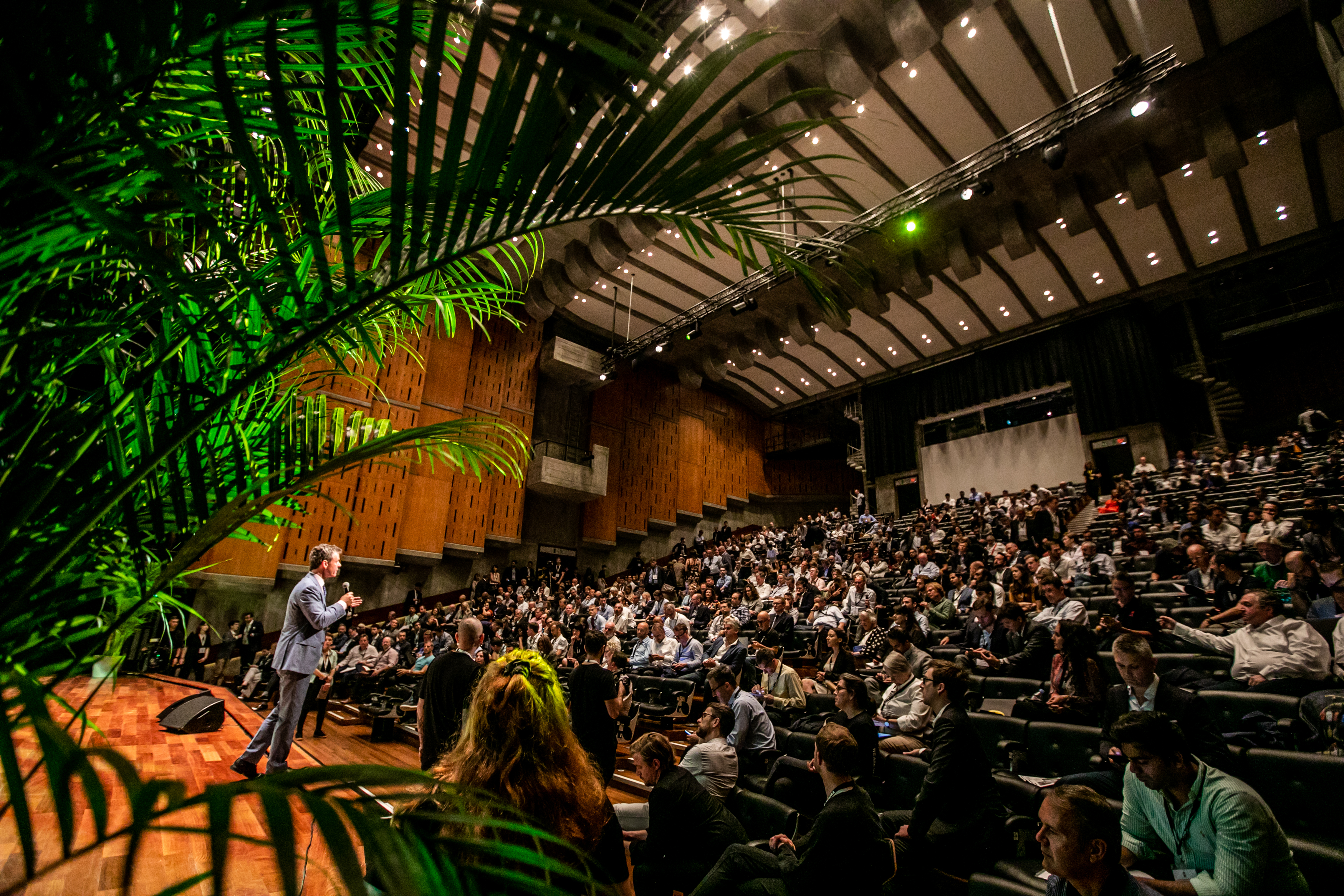 Queen Elizabeth Hall Auditorium conference with engaging speaker and vibrant greenery.