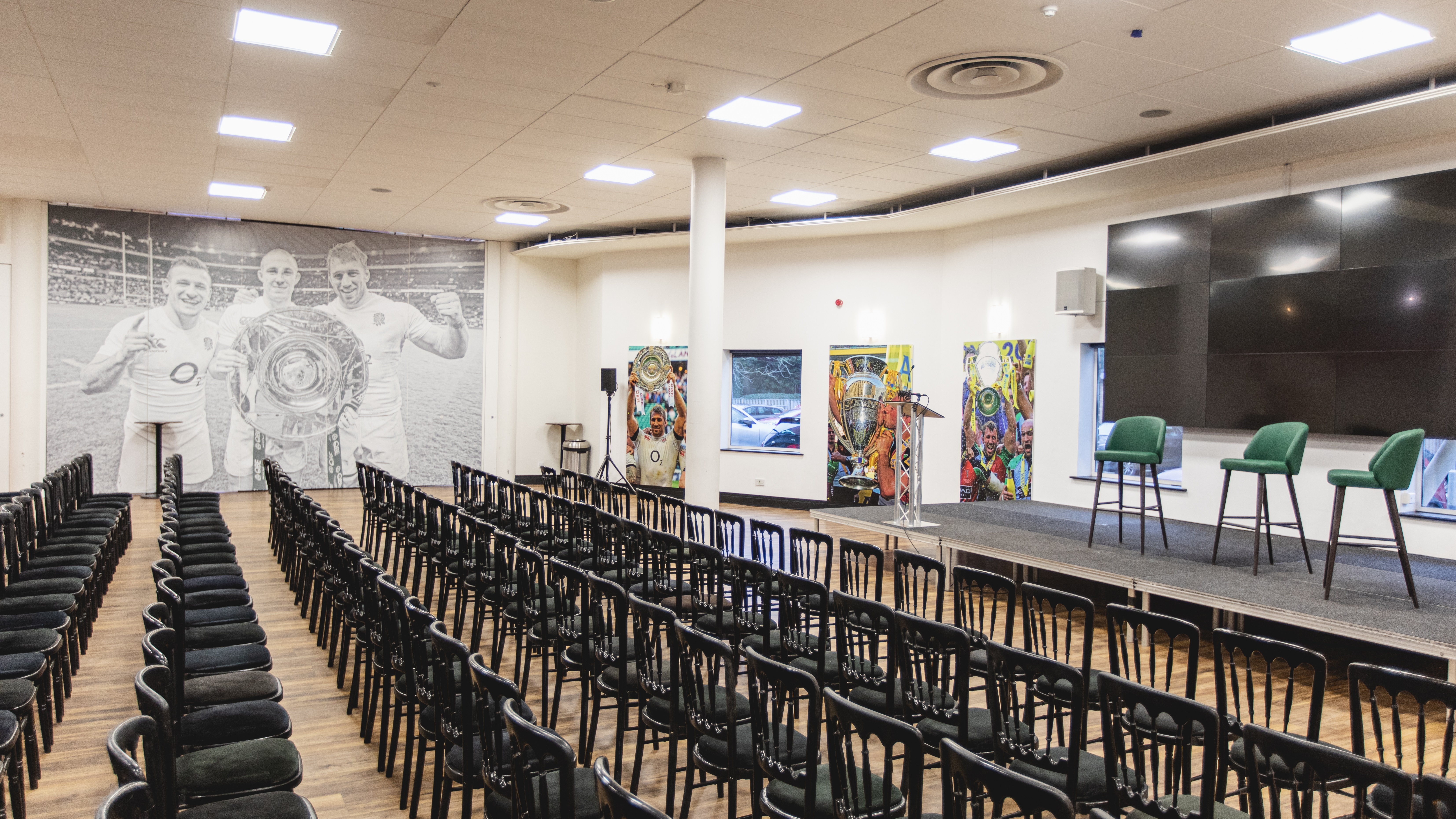 Chris Robshaw Bar event space with stage, chairs, and sports-themed decor for corporate meetings.