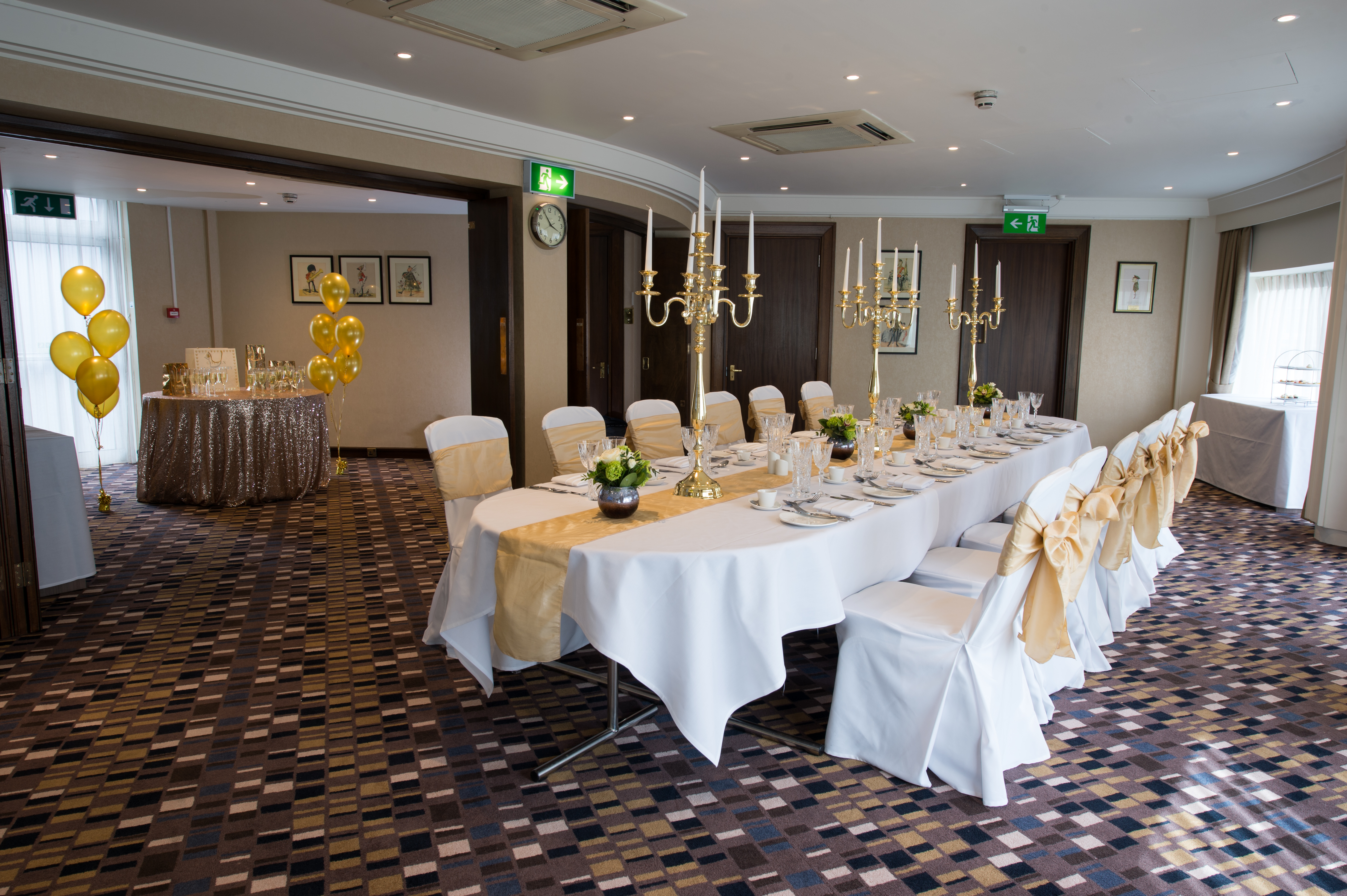 Elegant event space at Victory Services Club with gold accents for corporate gatherings.