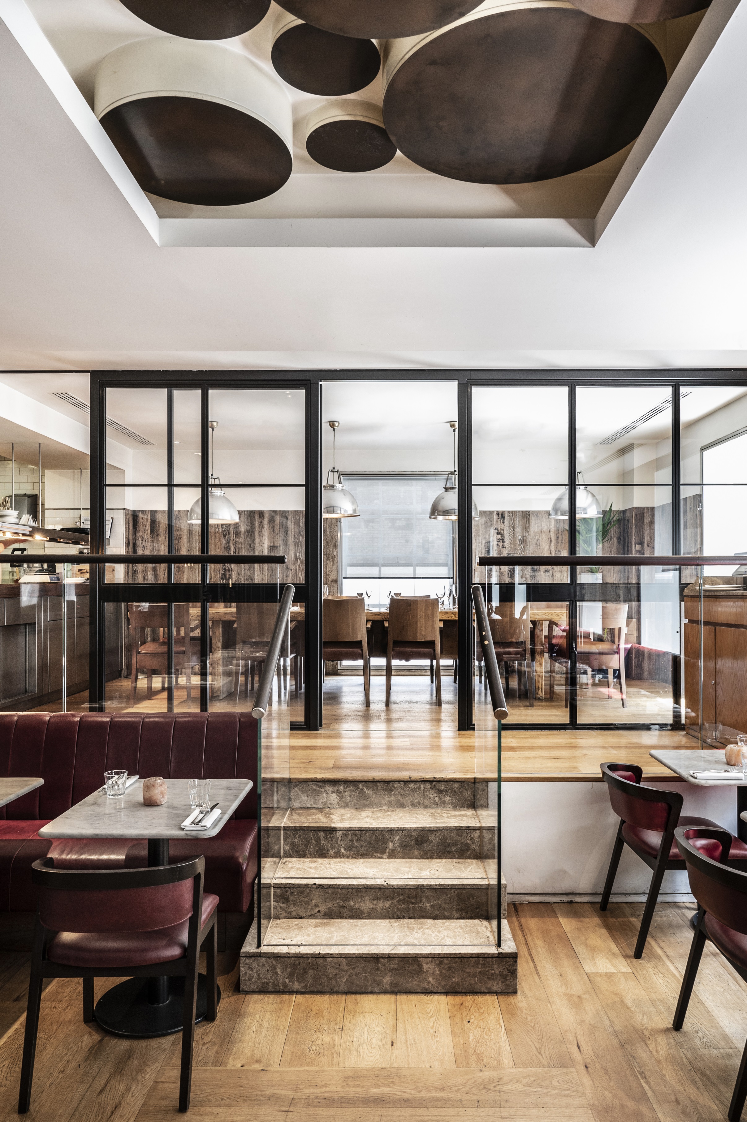 Butchers Block at Gordon Ramsay Bar and Grill: modern meeting space with glass enclosure.