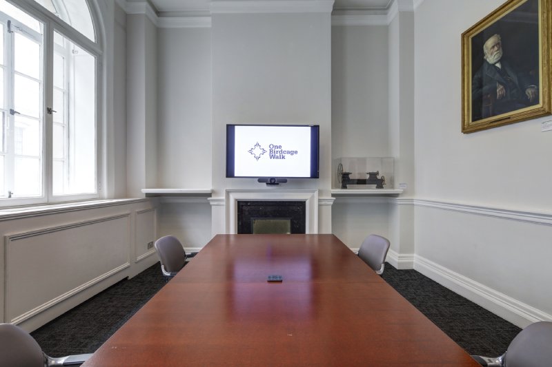 Joseph Whitworth meeting room with wooden table, ideal for presentations and discussions.