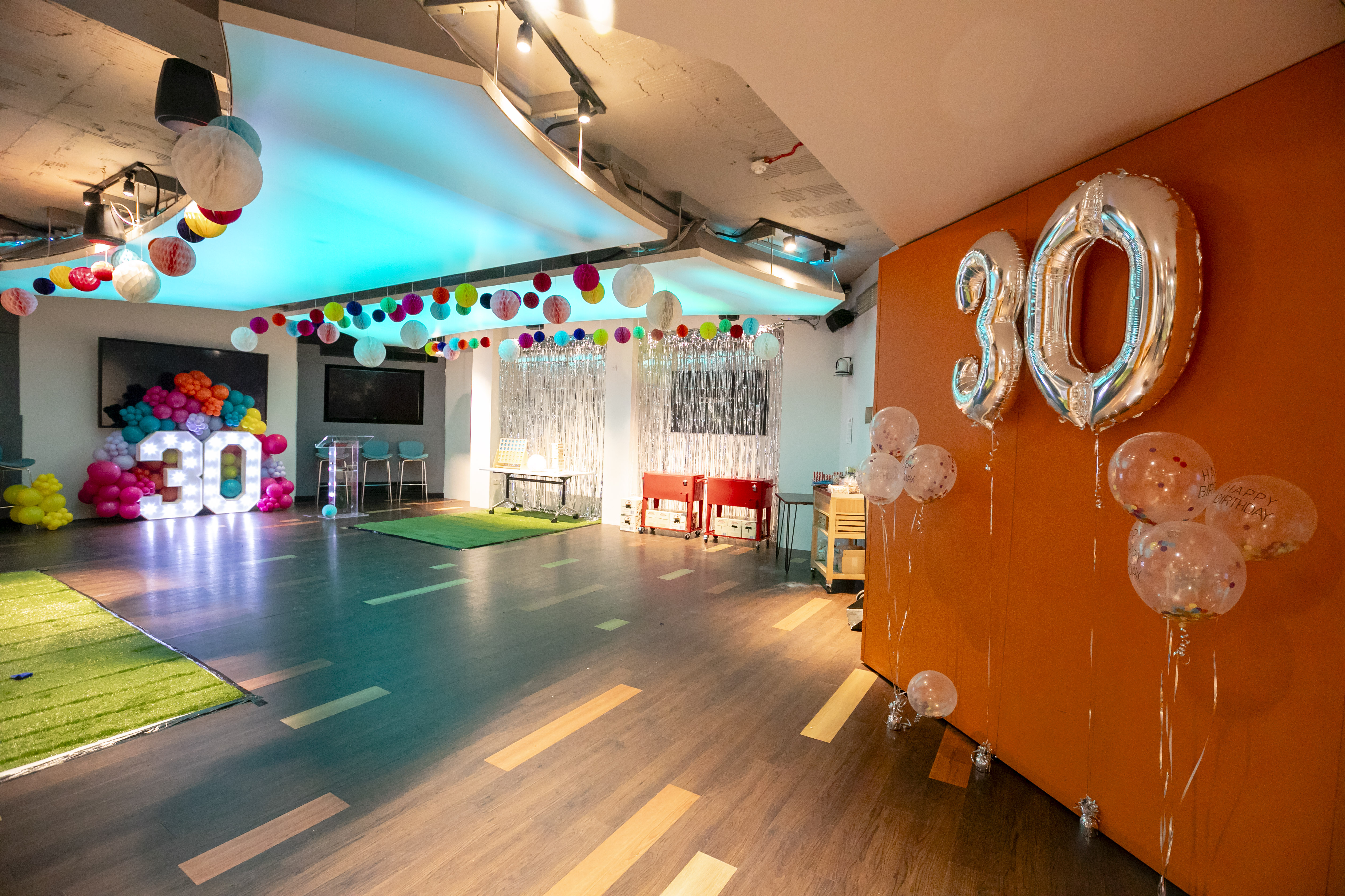 Vibrant event space with colorful decor for a 30th birthday celebration.