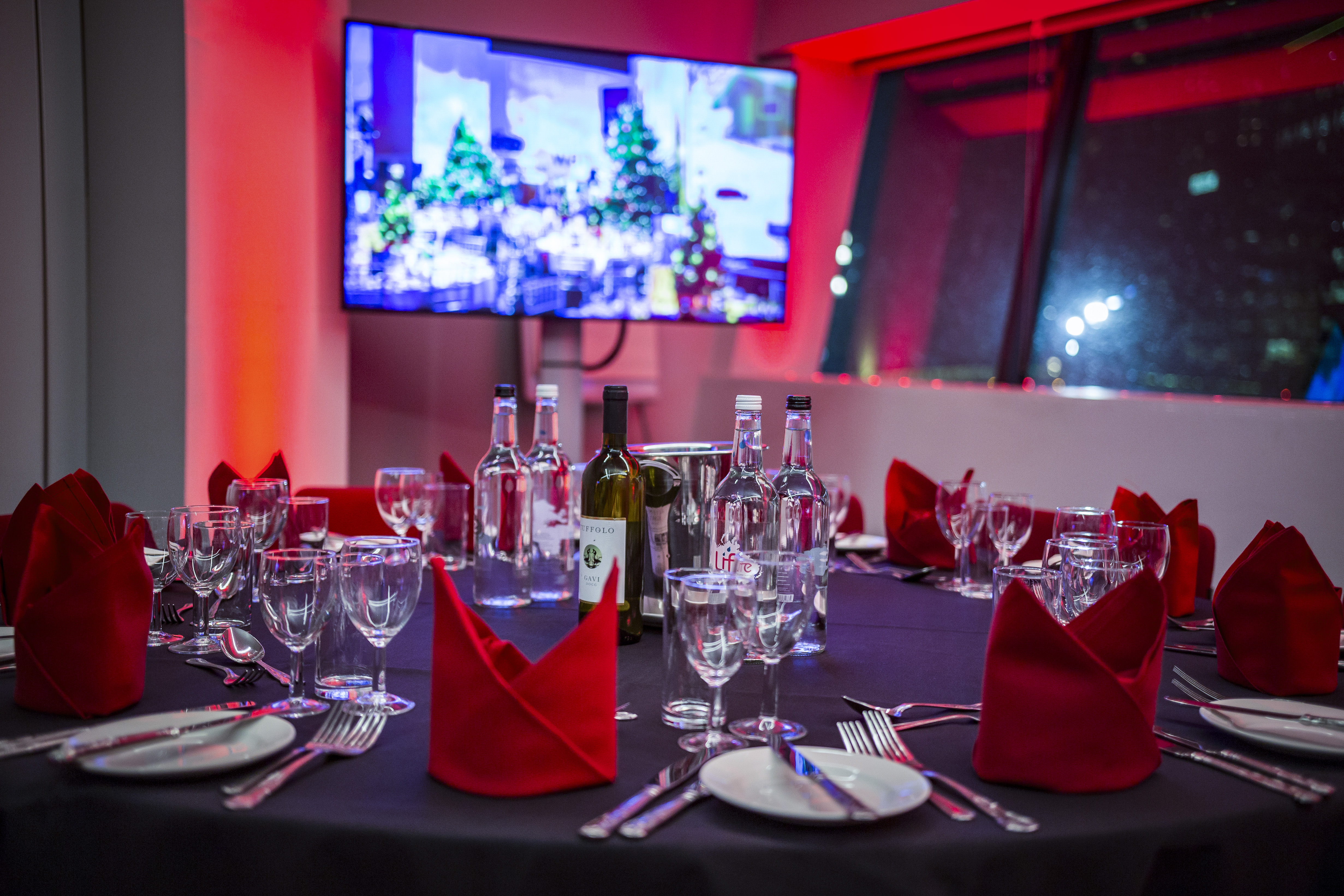 Elegant dining setup with red napkins at Imperial War Museum North event.