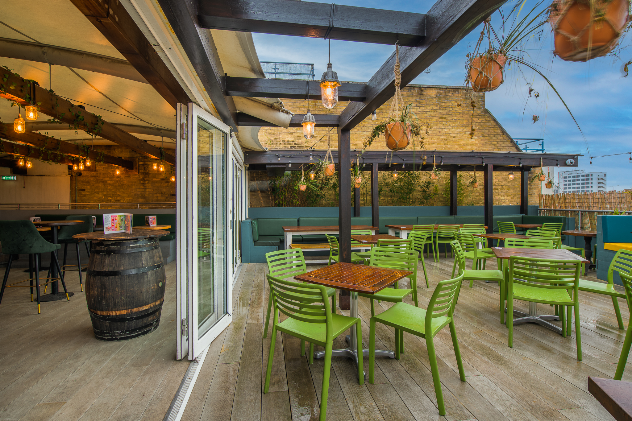 Sky Bar outdoor event space with modern green furniture, ideal for networking and gatherings.