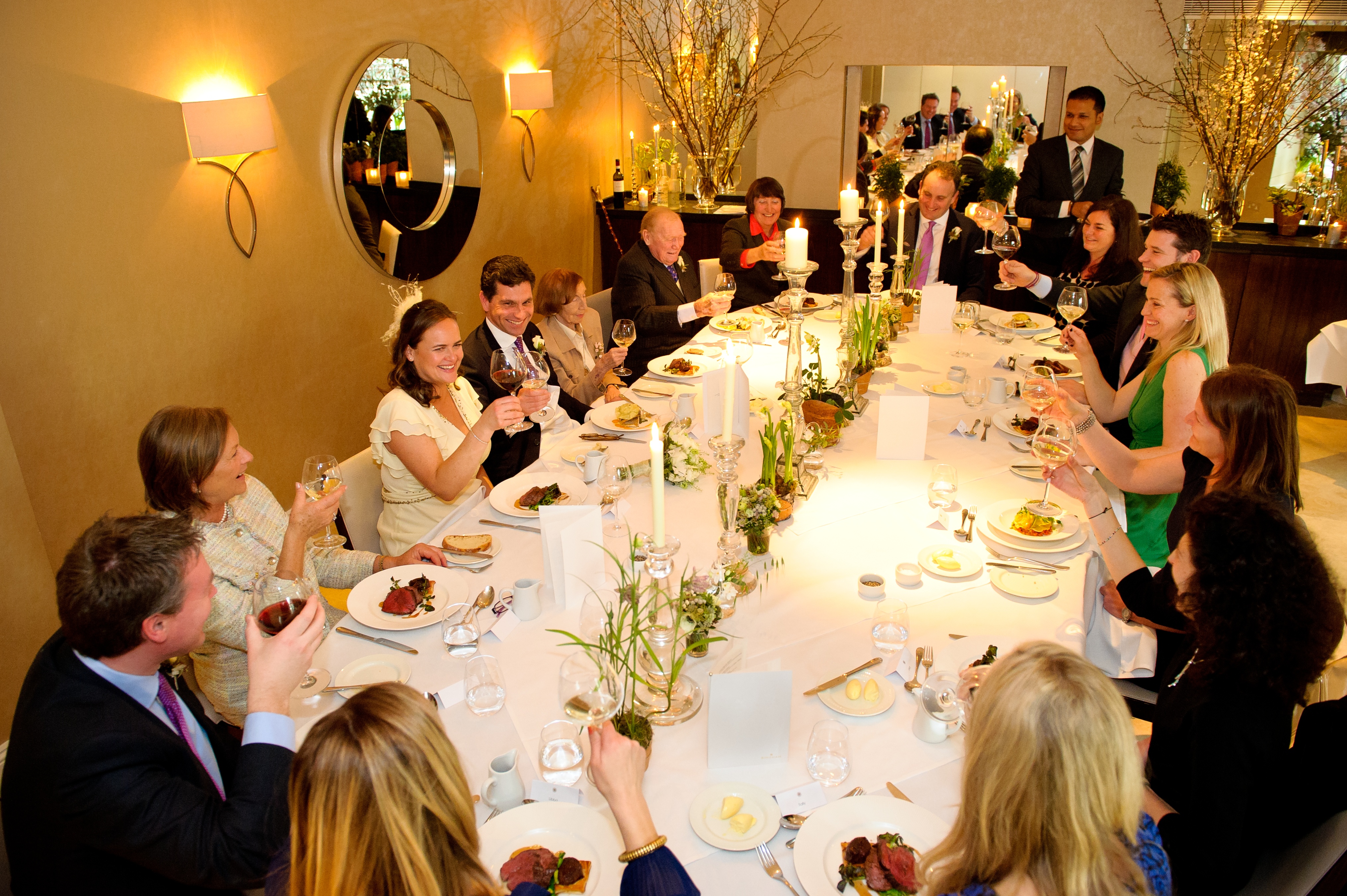 Elegant dinner event in The Bingham's Garden Room with warm lighting and floral decor.