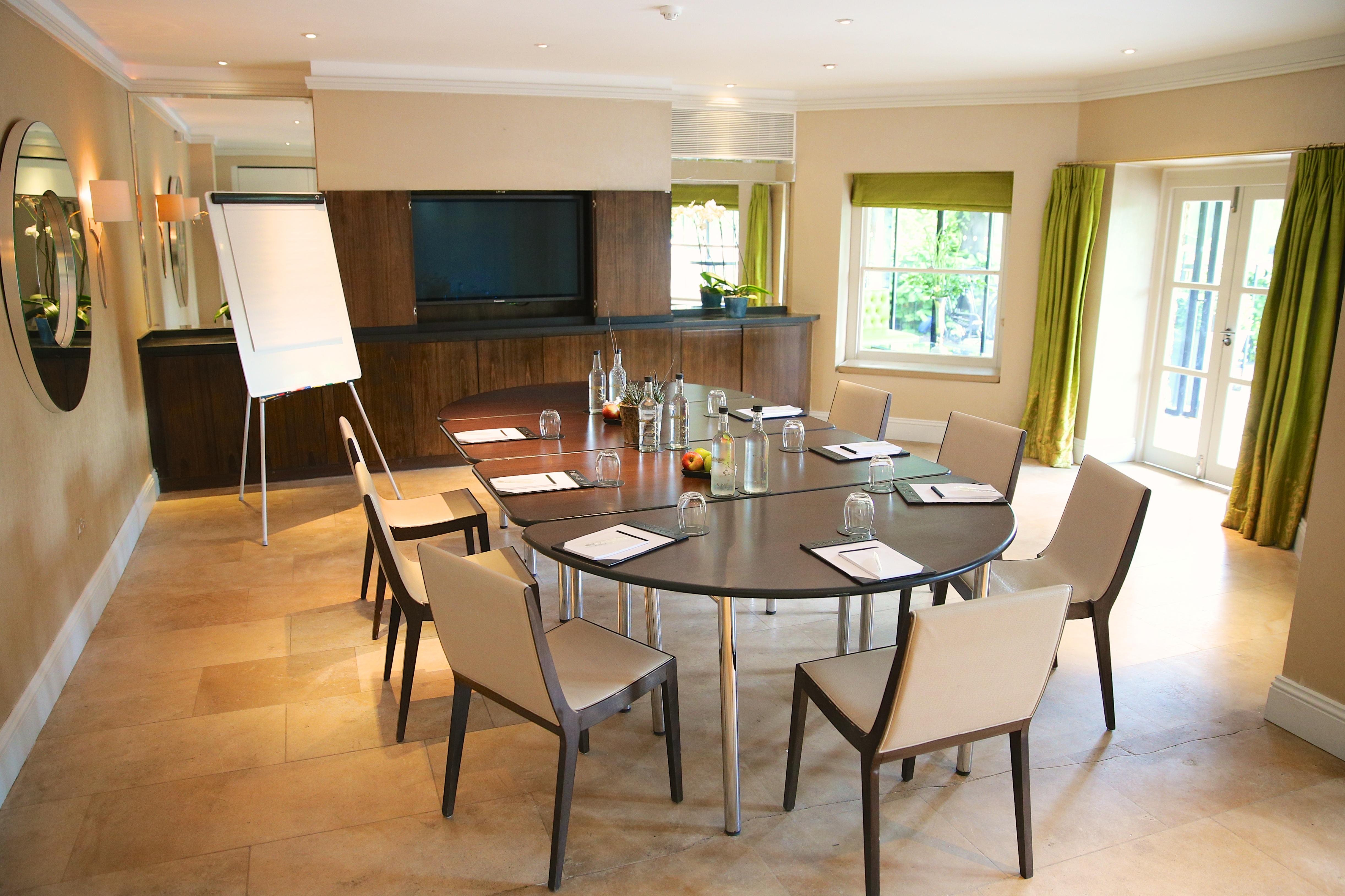 Garden Room 1 at The Bingham: modern meeting space with round table for corporate events.