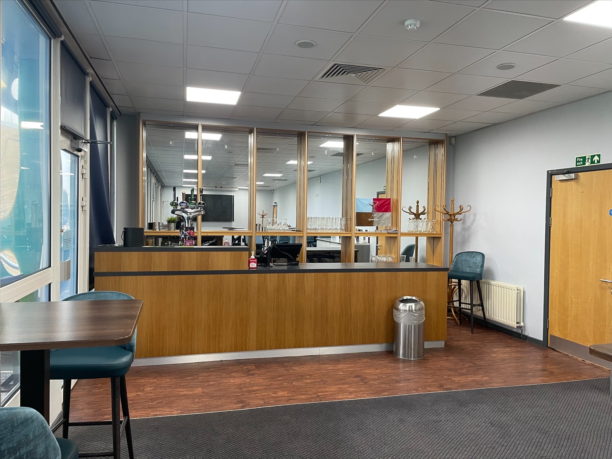 1866 Lounge at Twickenham Stoop, featuring a sleek wooden counter for events and meetings.