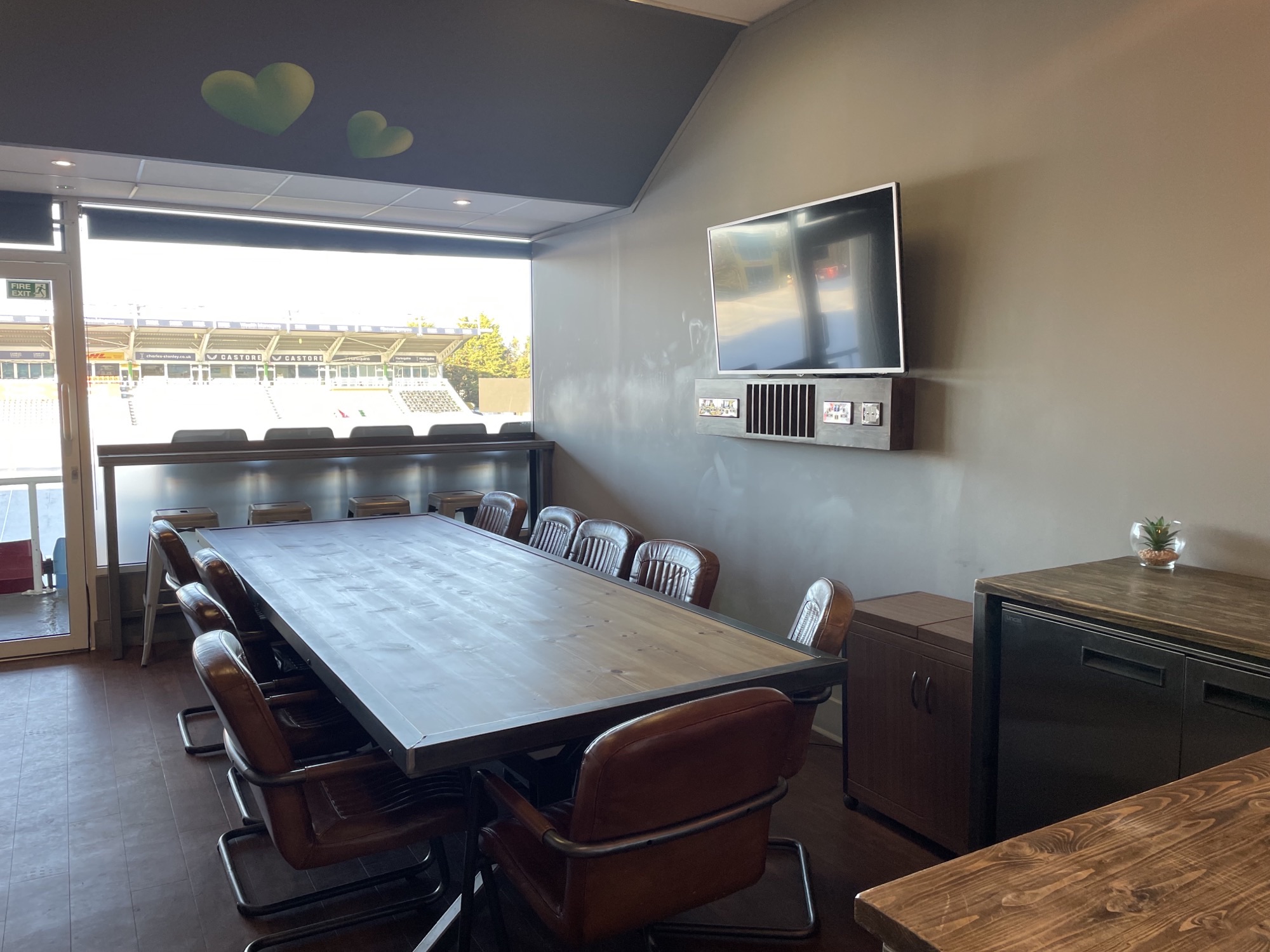 Modern executive meeting room with large table at Twickenham Stoop Stadium.