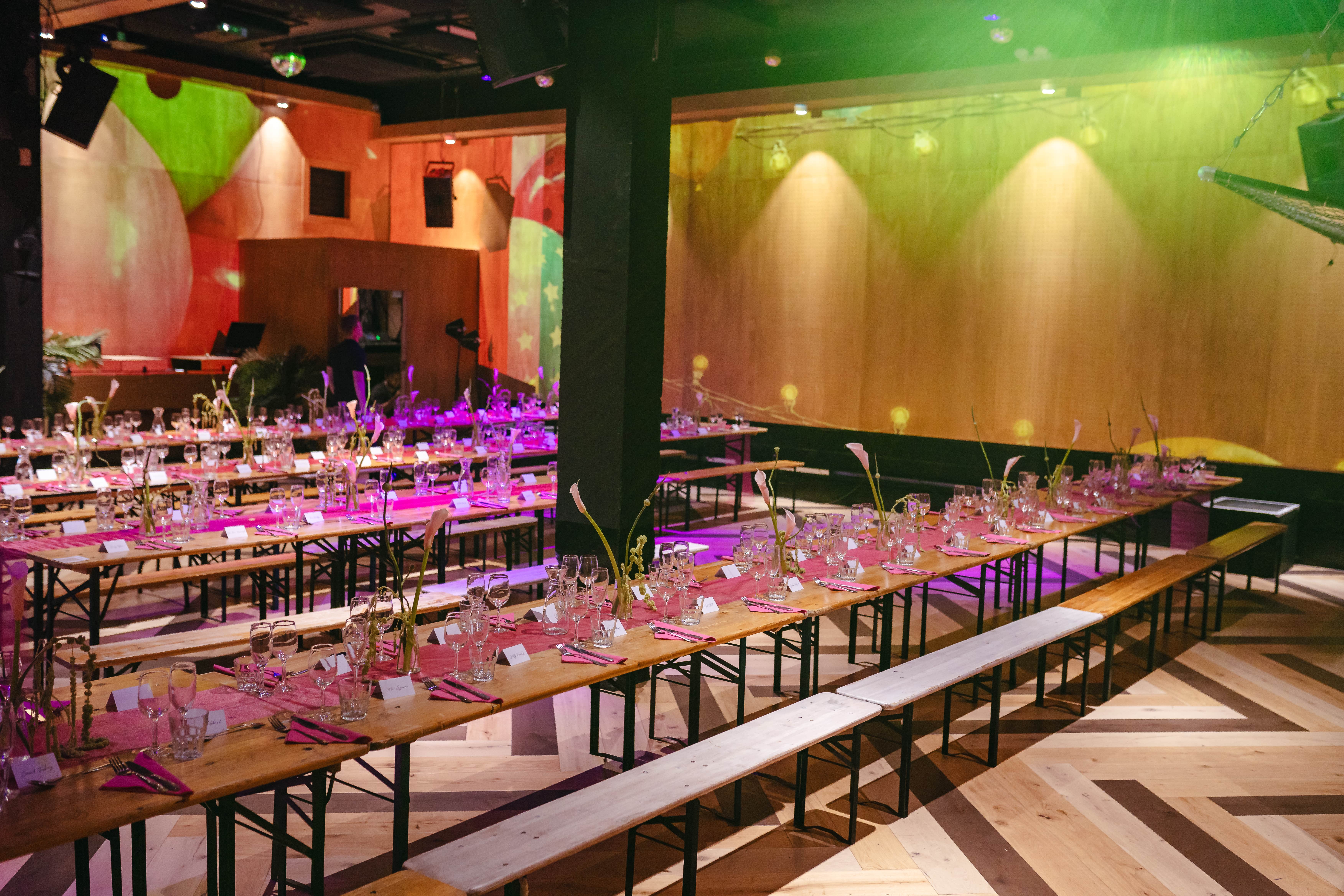 Vibrant event space with pink table settings ideal for corporate gatherings and celebrations